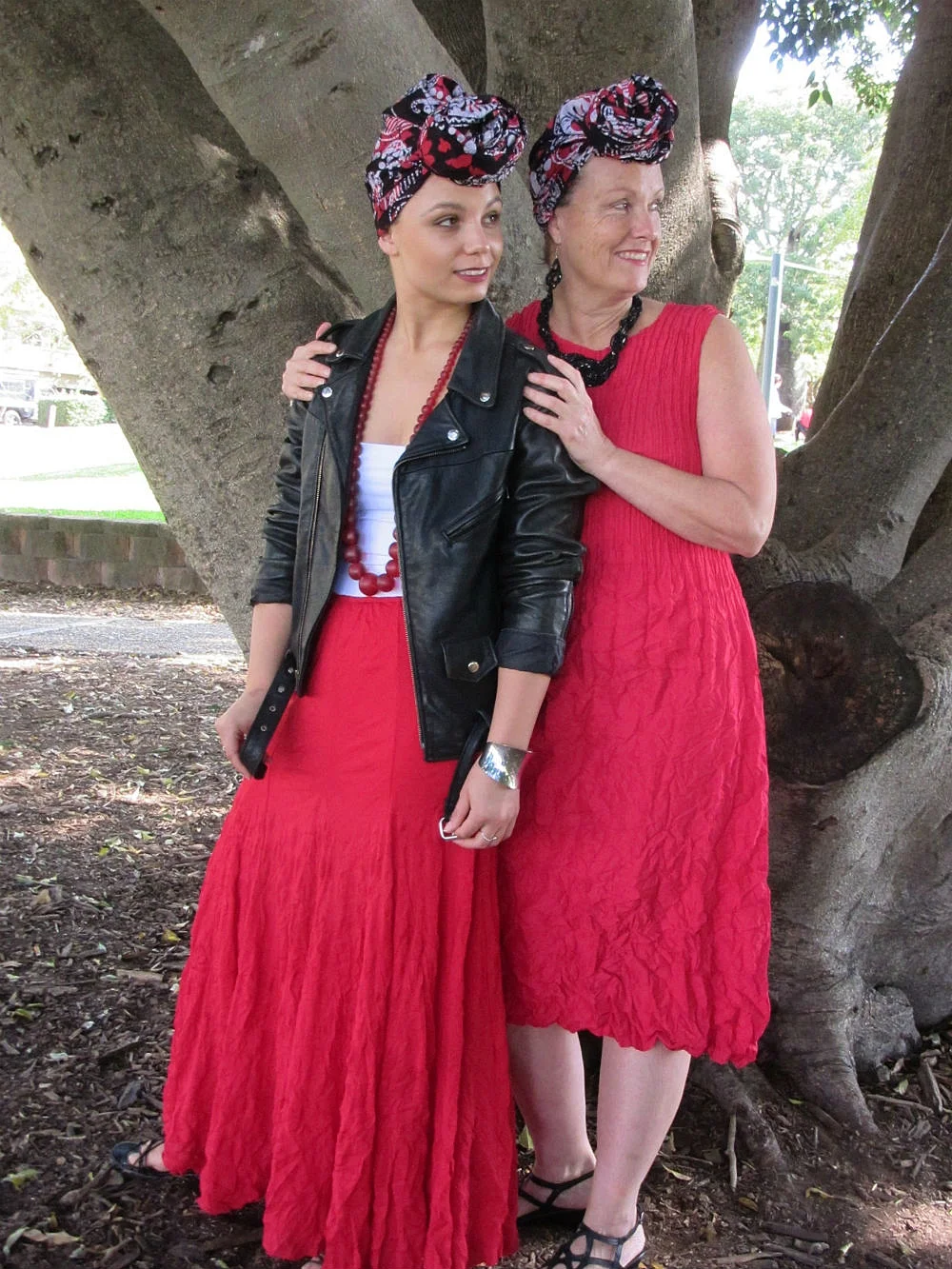 Mama Karen and daughter Zabrina wear batik headwrap GARNET - colour palette red, white and black - look, smart/casual. Headwrap styled in THE TOPKNOT.
