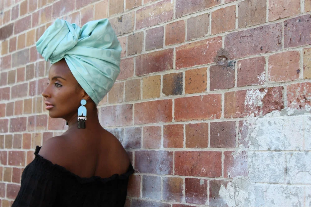 Yeni looks stunning in our limited edition African bazin headwrap design. We've named her TURQUOISE and teamed her with earrings from Melbourne based jewellery designer Ovazania.