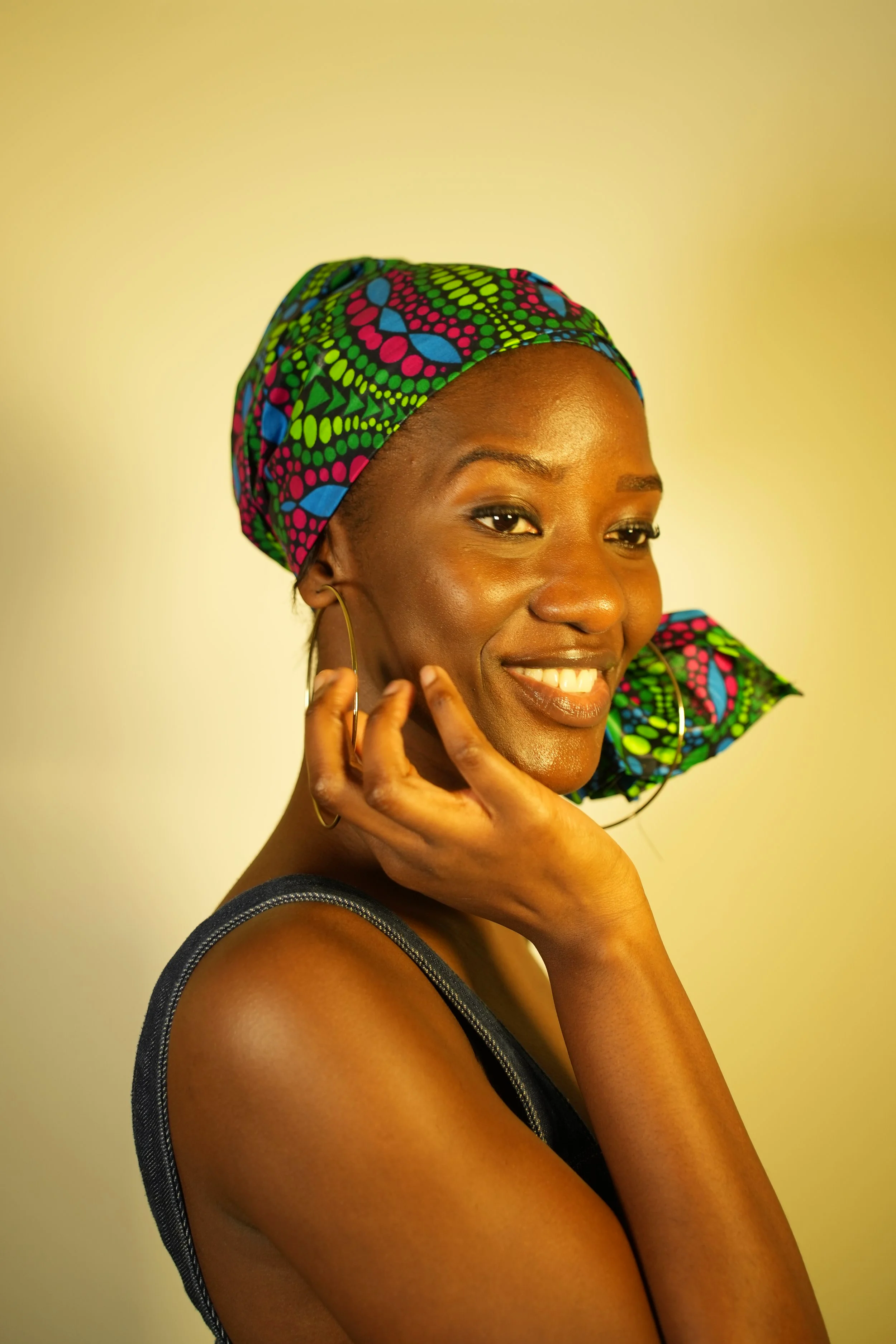Woman smiling and wearing a headwrap
