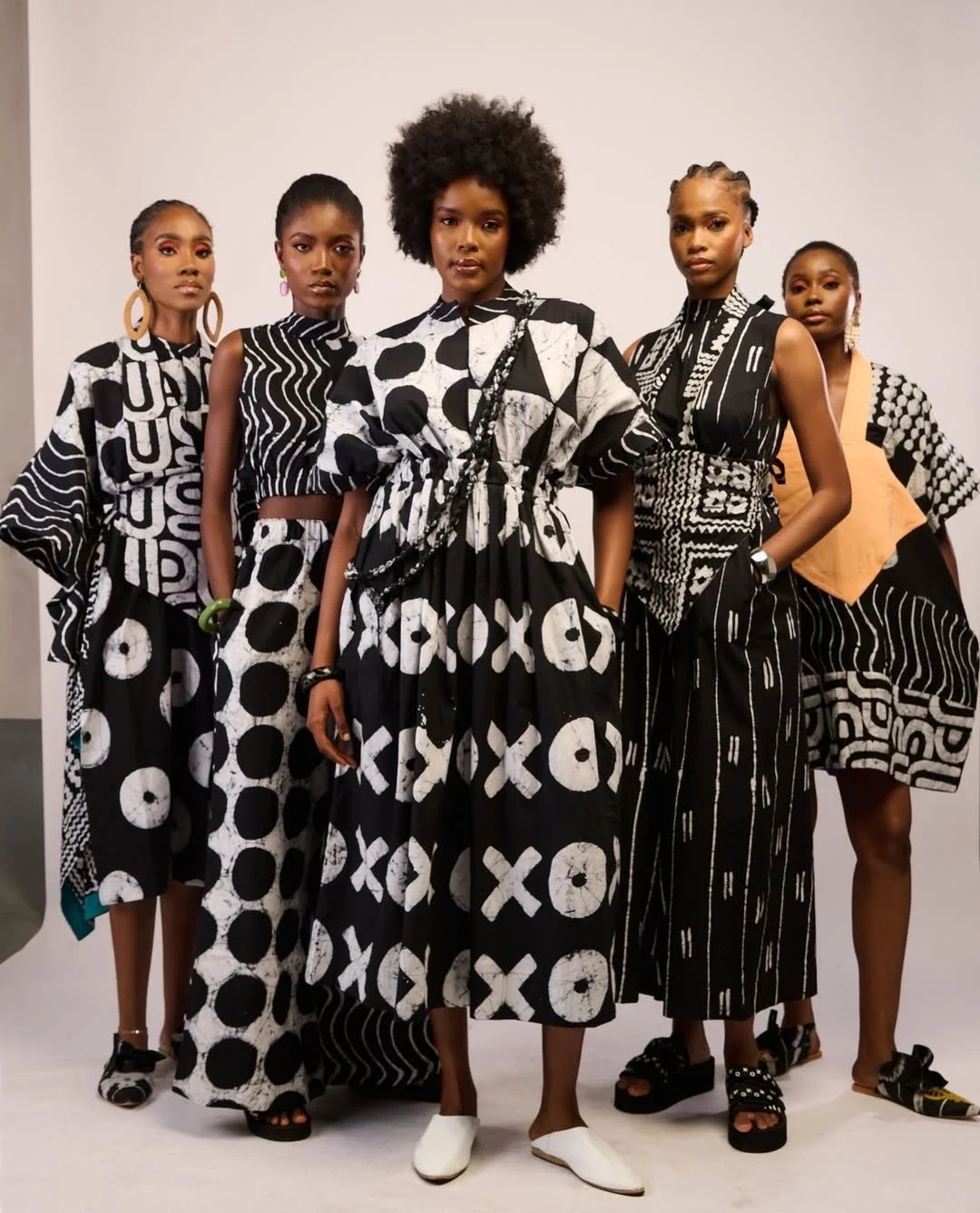 A group of women wearing outfits in black and white tie dye