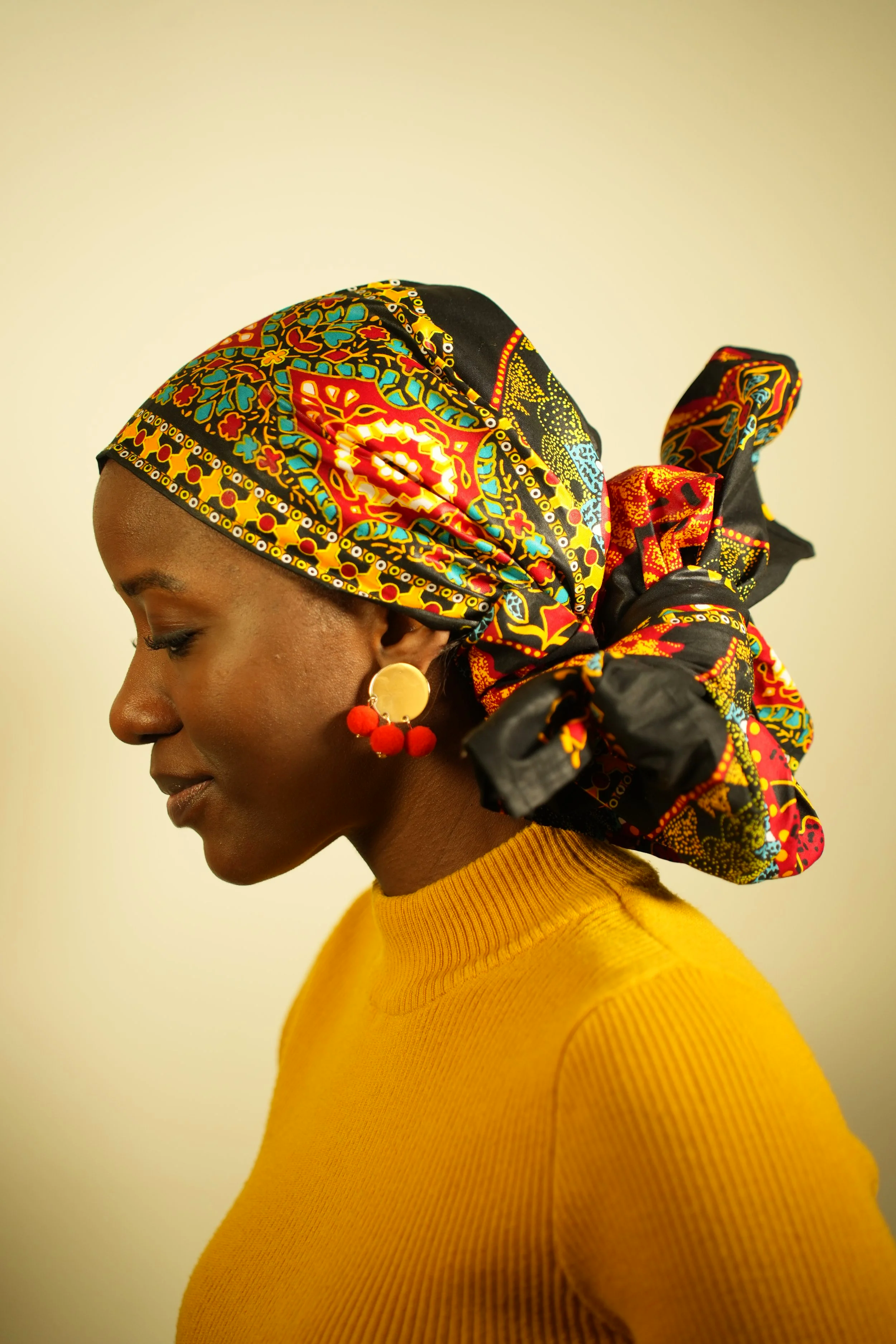 Woman looking down and wearing a headwrap