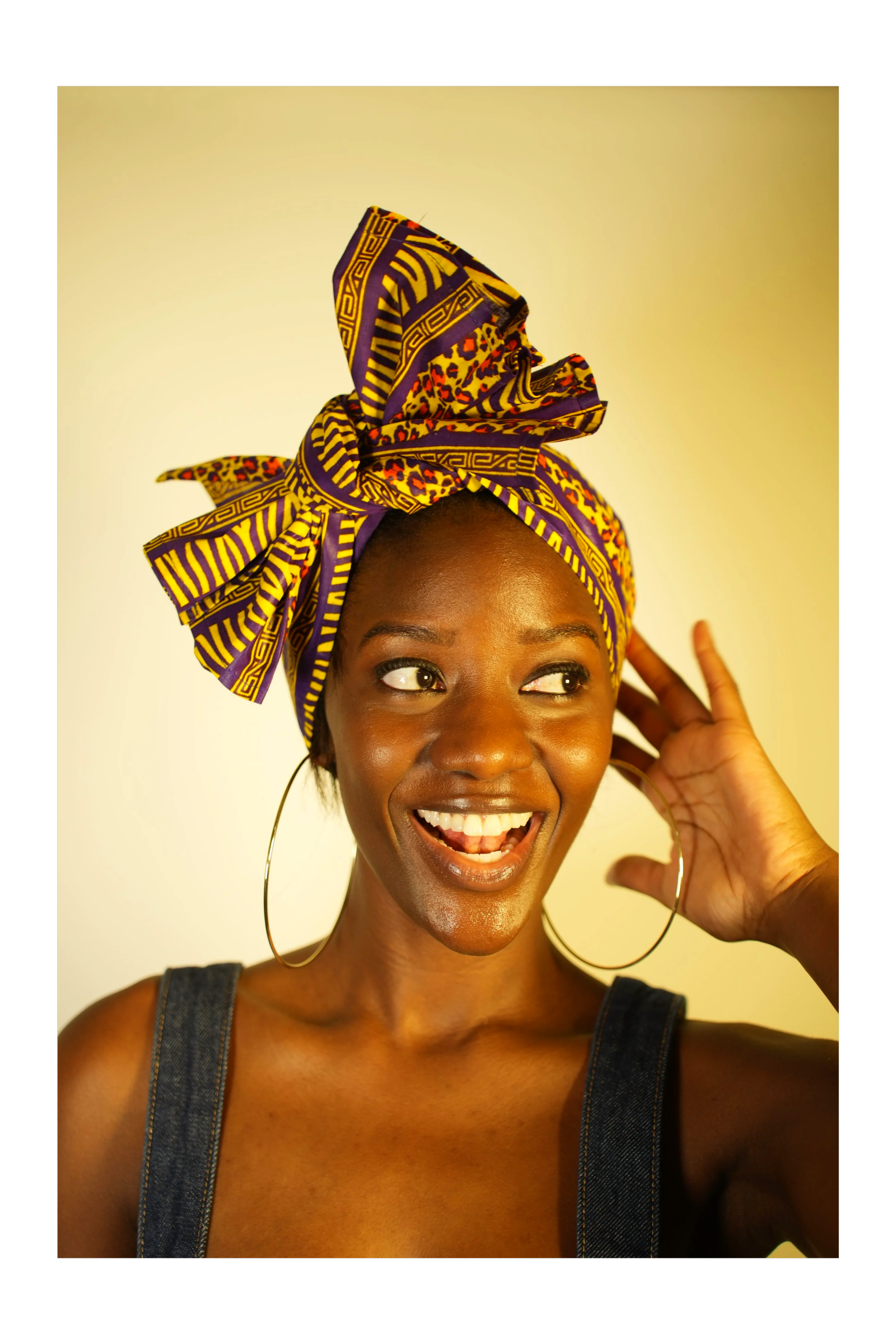 Woman smiling and wearing a headwrap