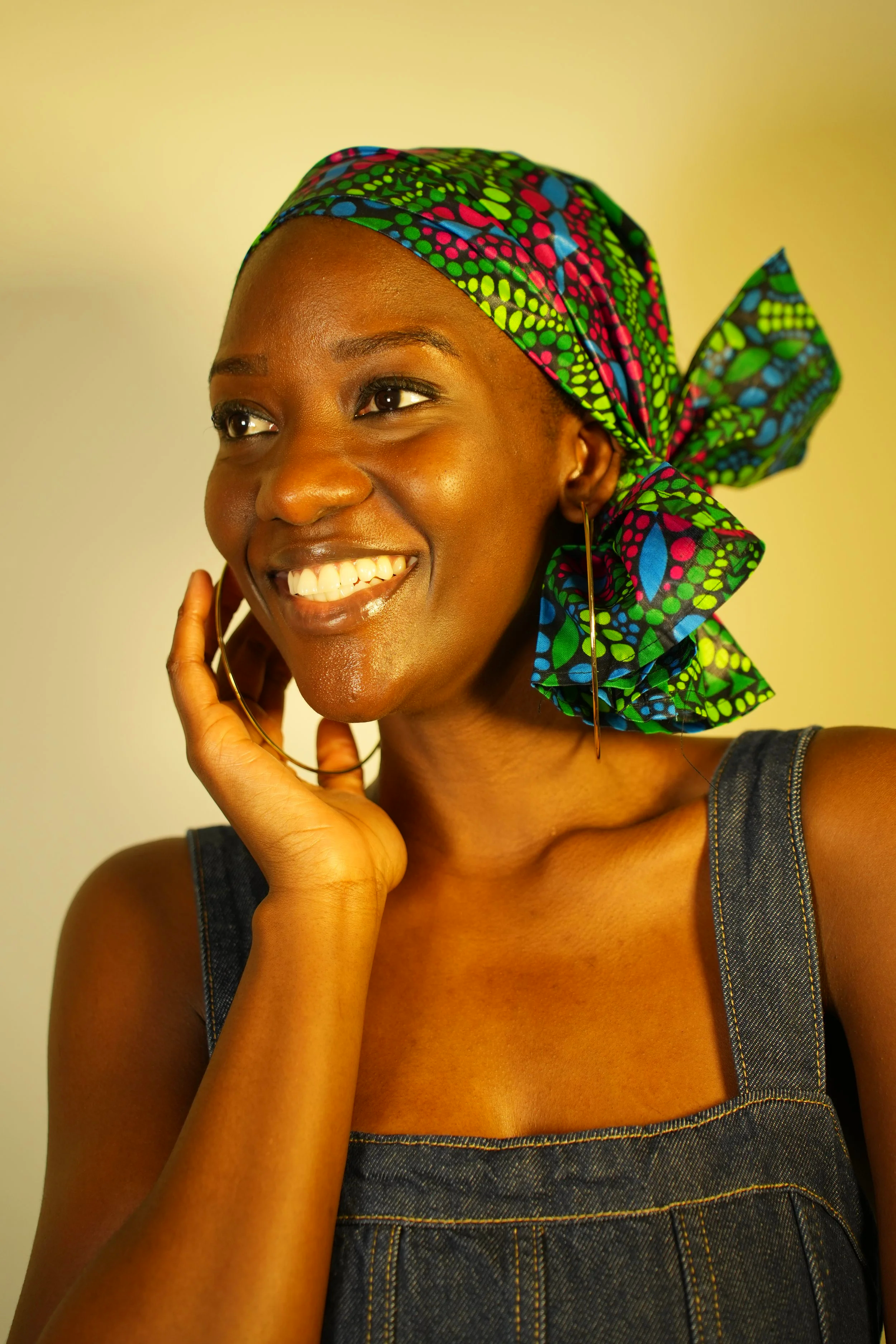 Woman smiling and wearing a headwrap