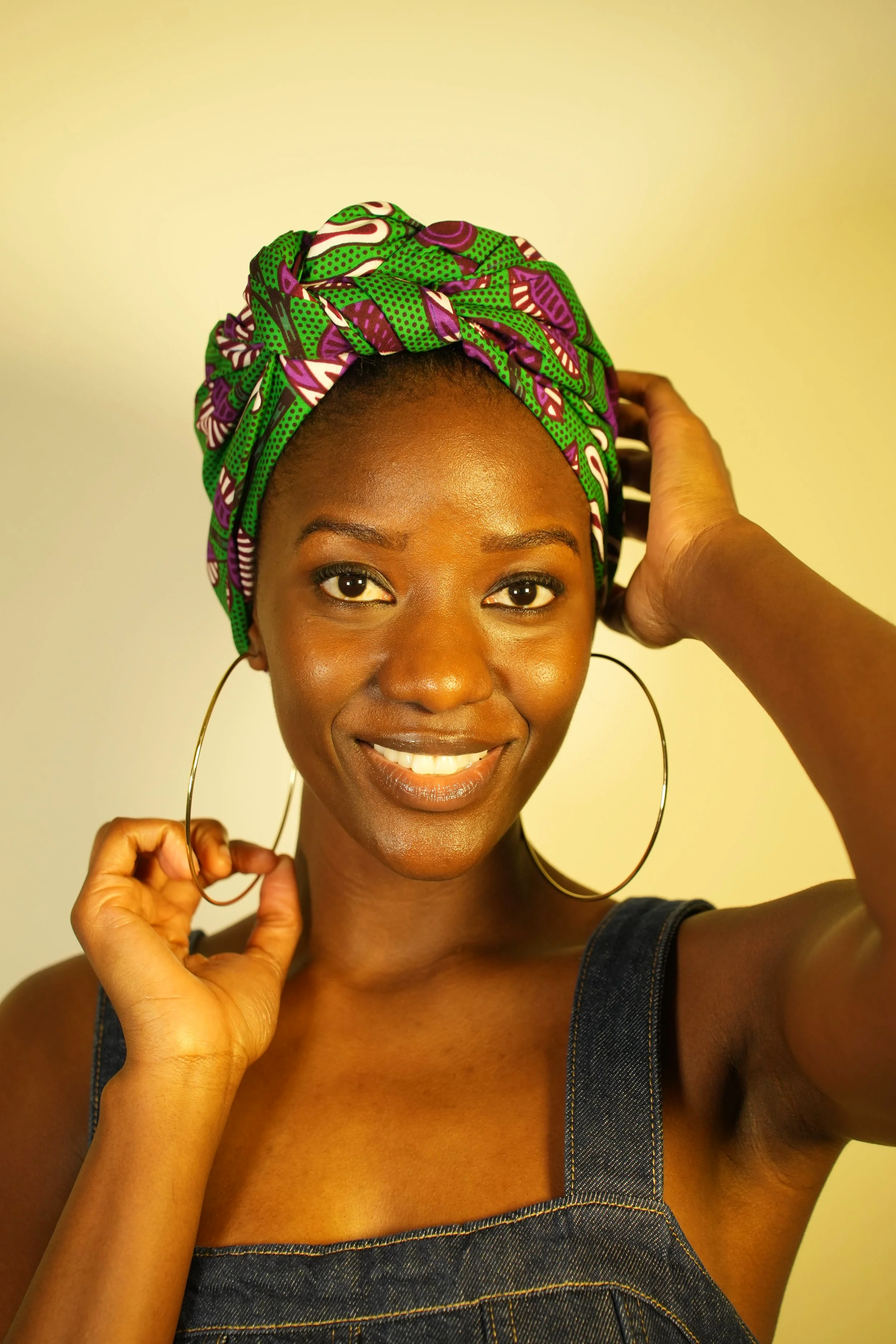 Front view of woman smiling and wearing a headwrap