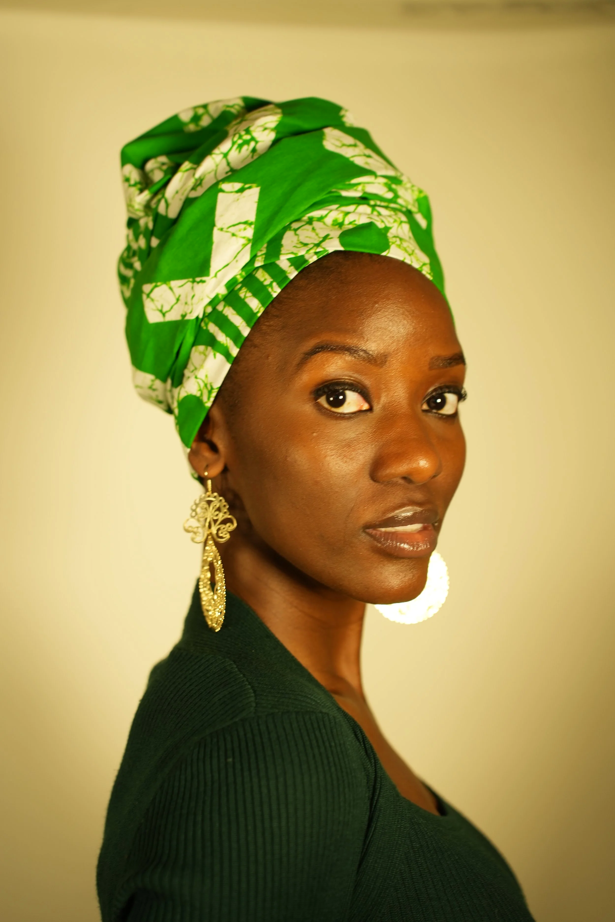 Woman looking at camera and wearing a headwrap