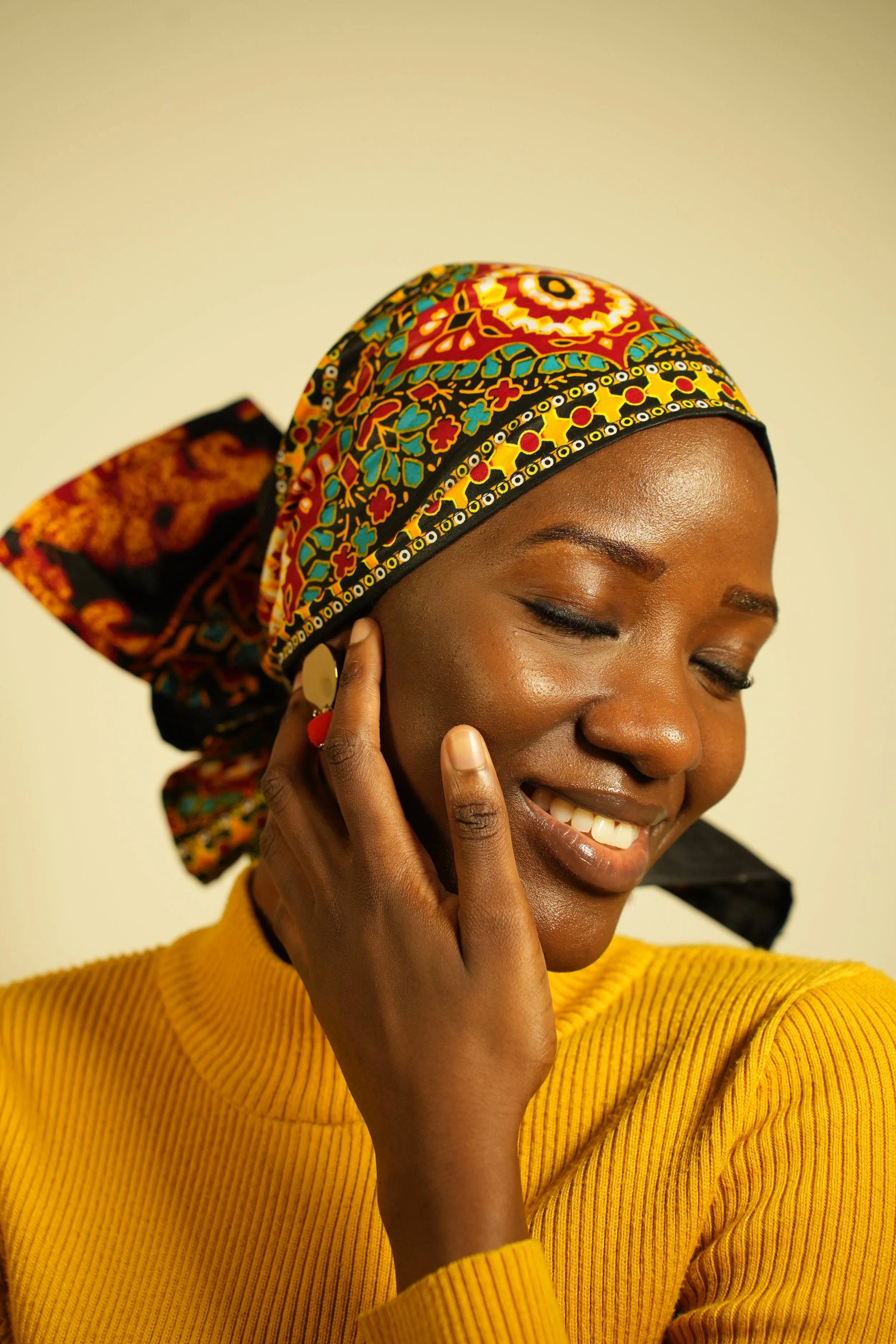 Woman eyes closed and wearing a headwrap