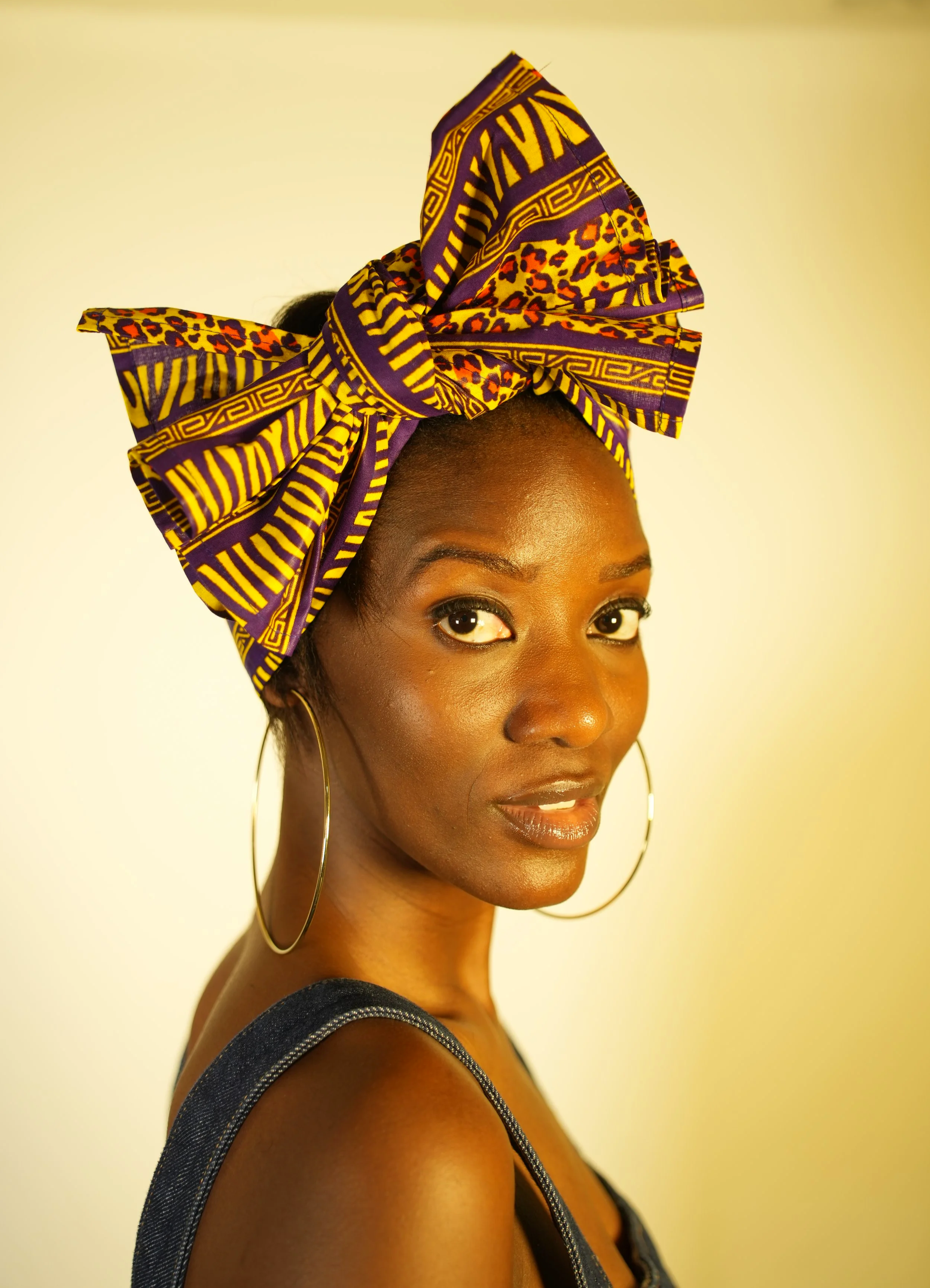 Woman looking at camera and wearing a headwrap