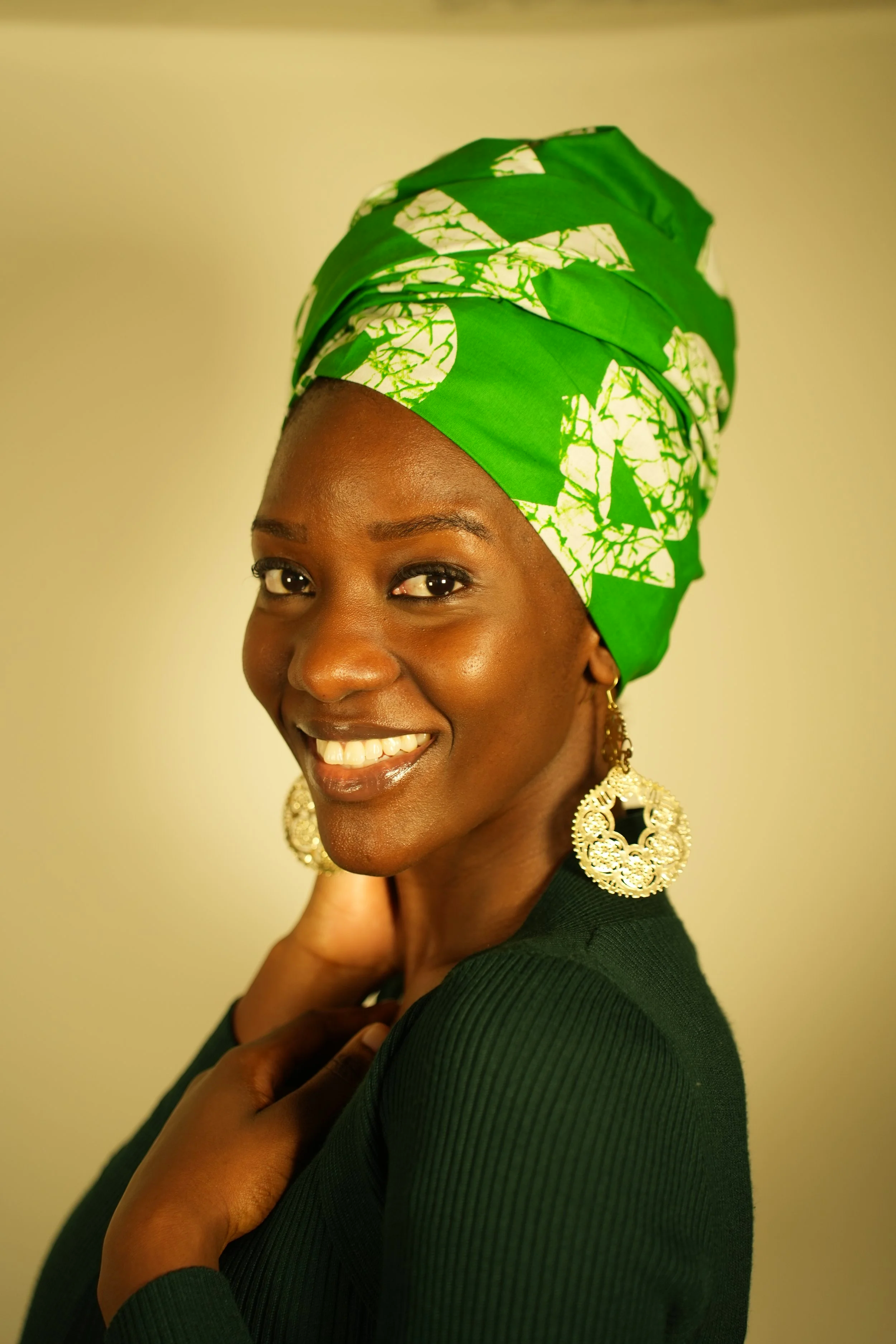 Woman smiling and wearing a headwrap