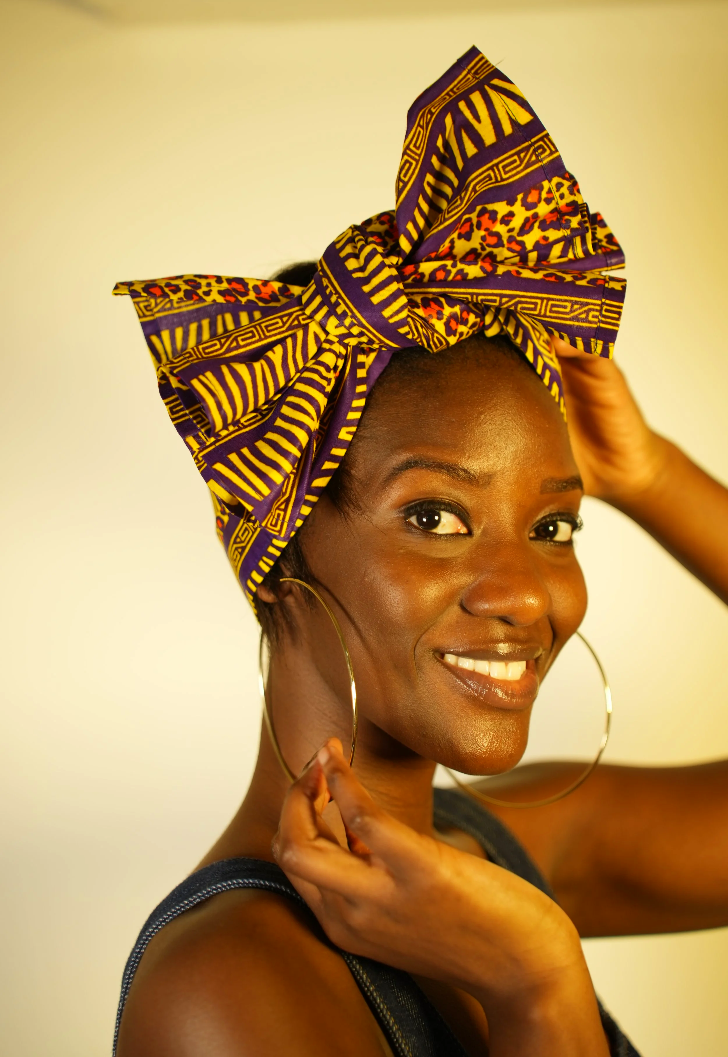 Woman smiling and wearing a headwrap