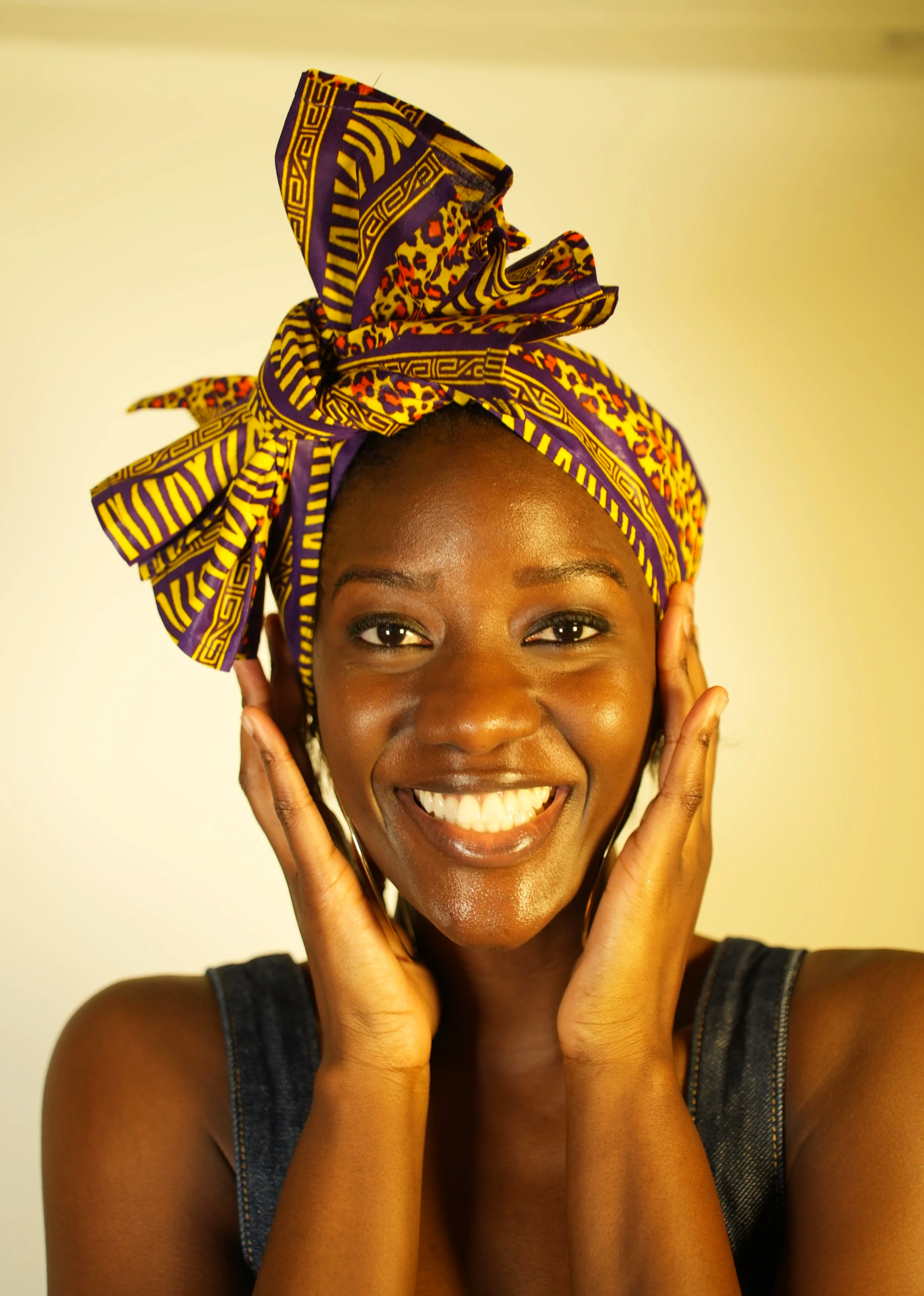 Woman smiling and wearing a headwrap