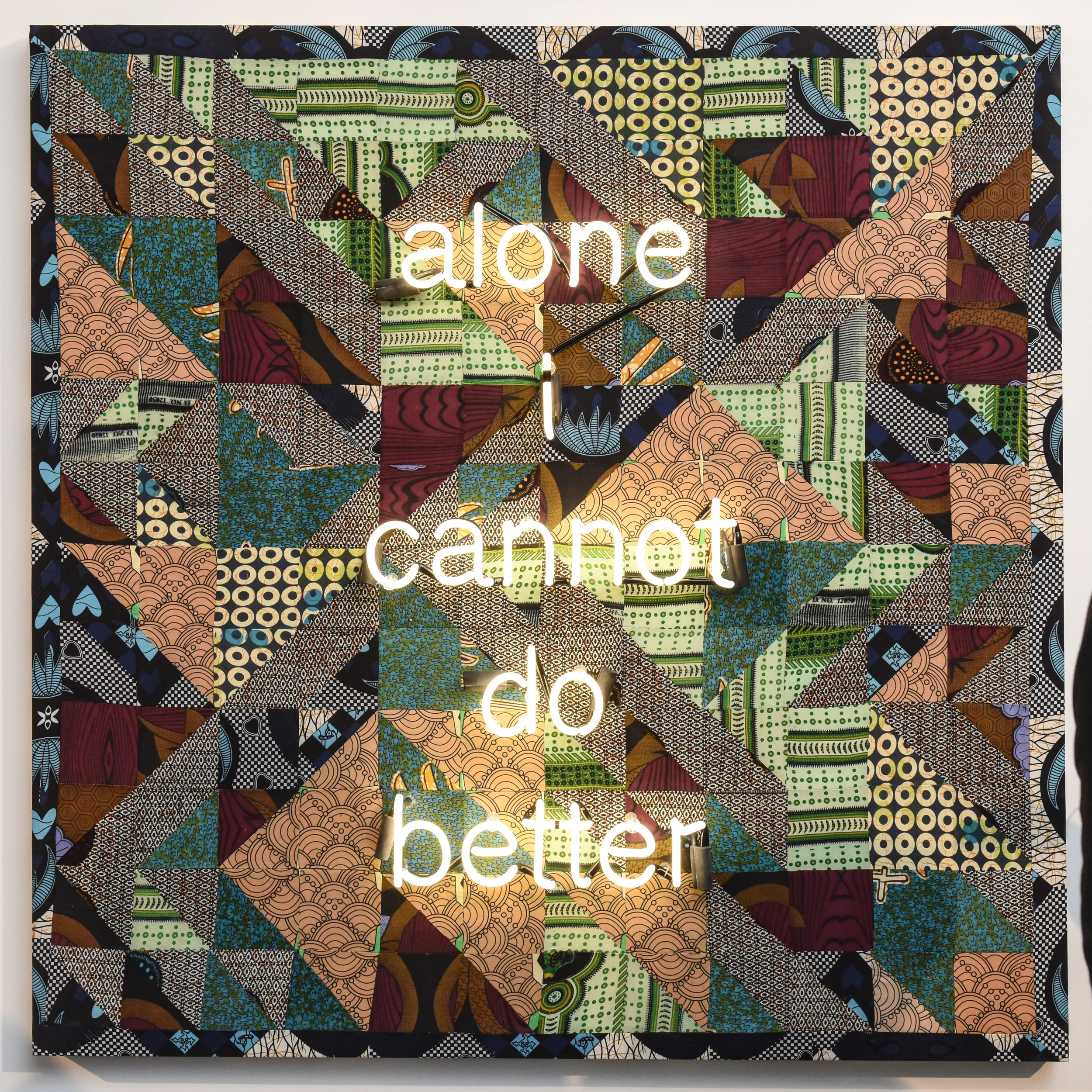 Zoë Buckman, Alone I Cannot Do Better , 2016, Quilted fabrics and neon mounted on board, 60" x 60"; Photo credit: BFA.com