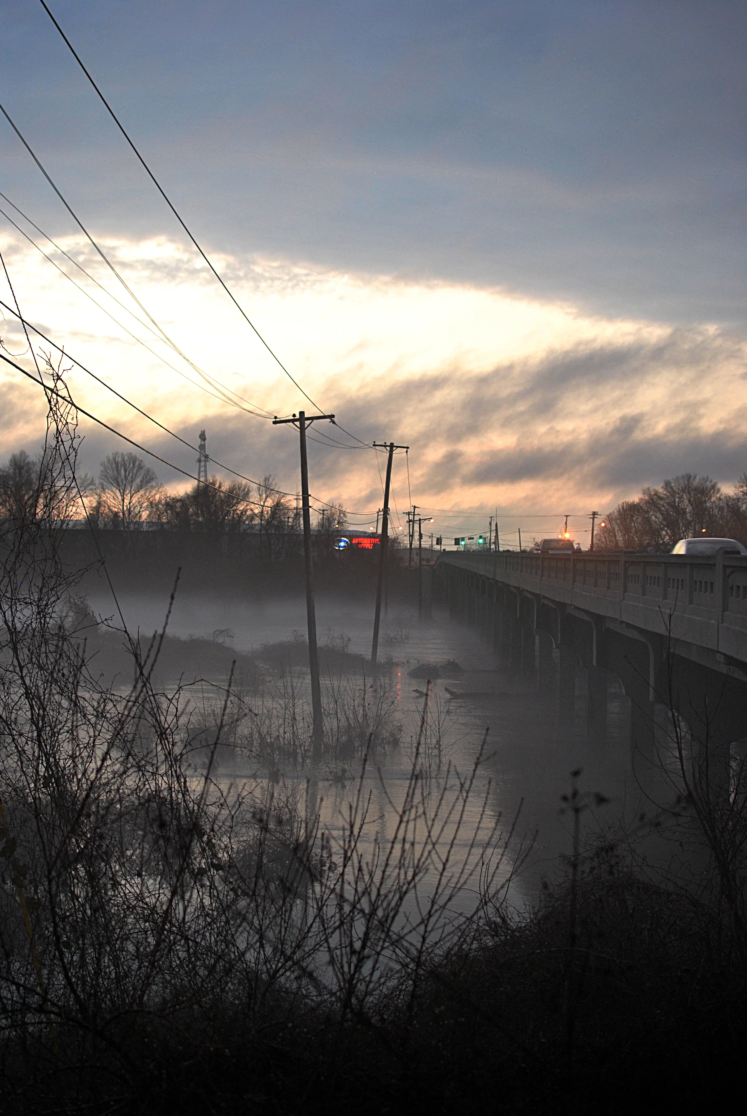 See the twin forms between the light poles and the bridge? Serpentine in nature, like the Loch Ness Monster!