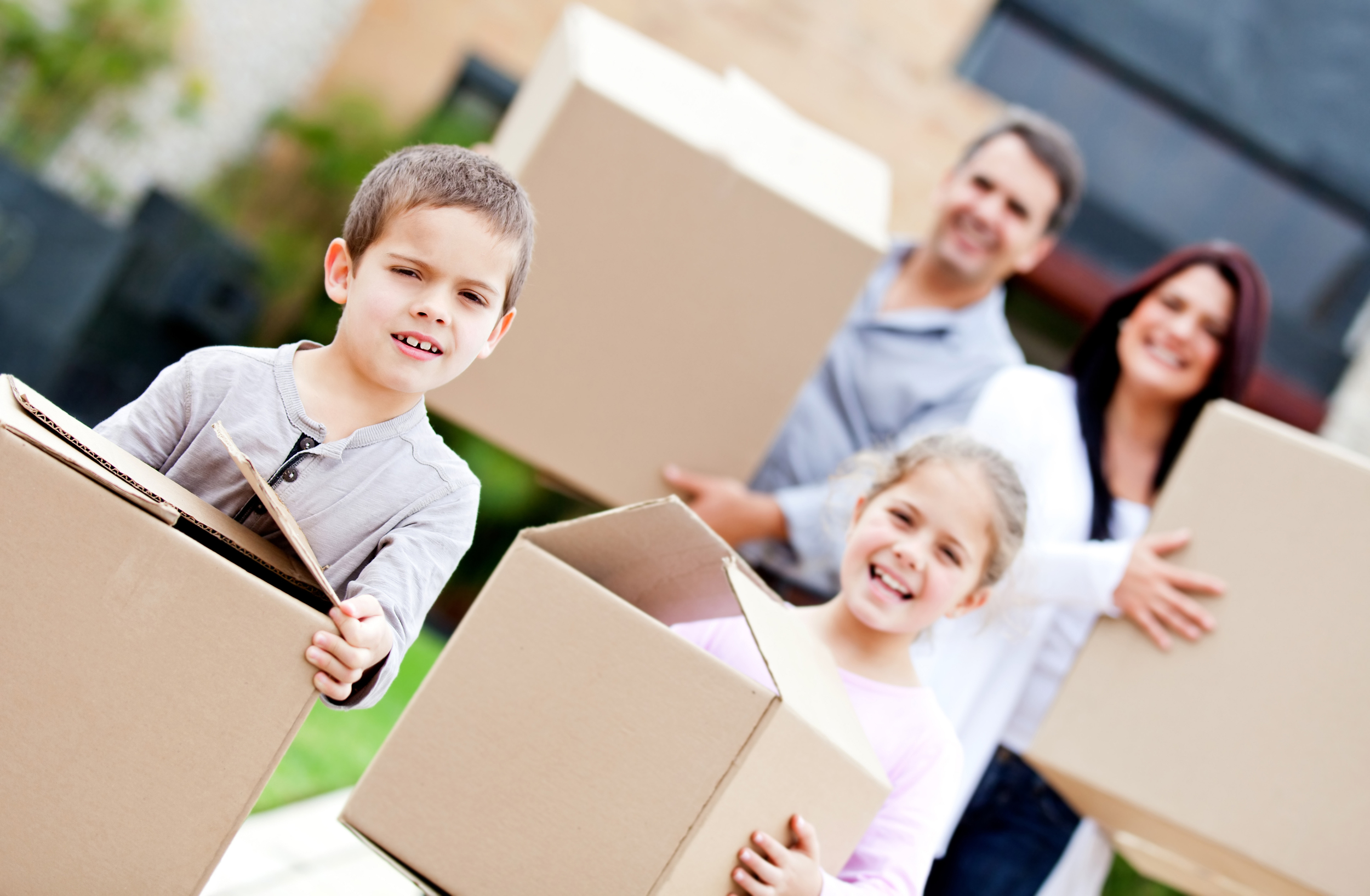 family with boxes moving to new property