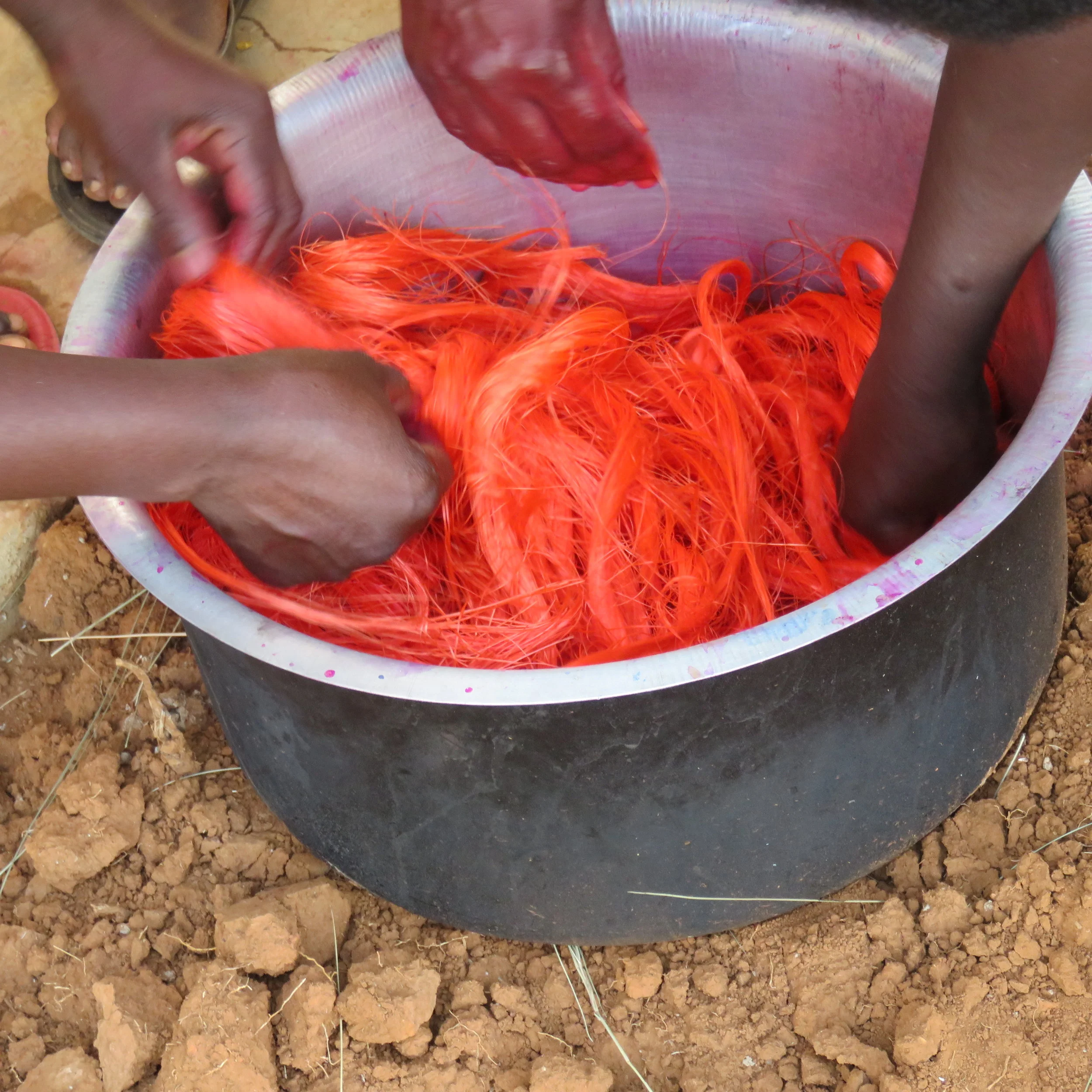 Figure 5: Stirring the fiber into the orange-coloring solution.