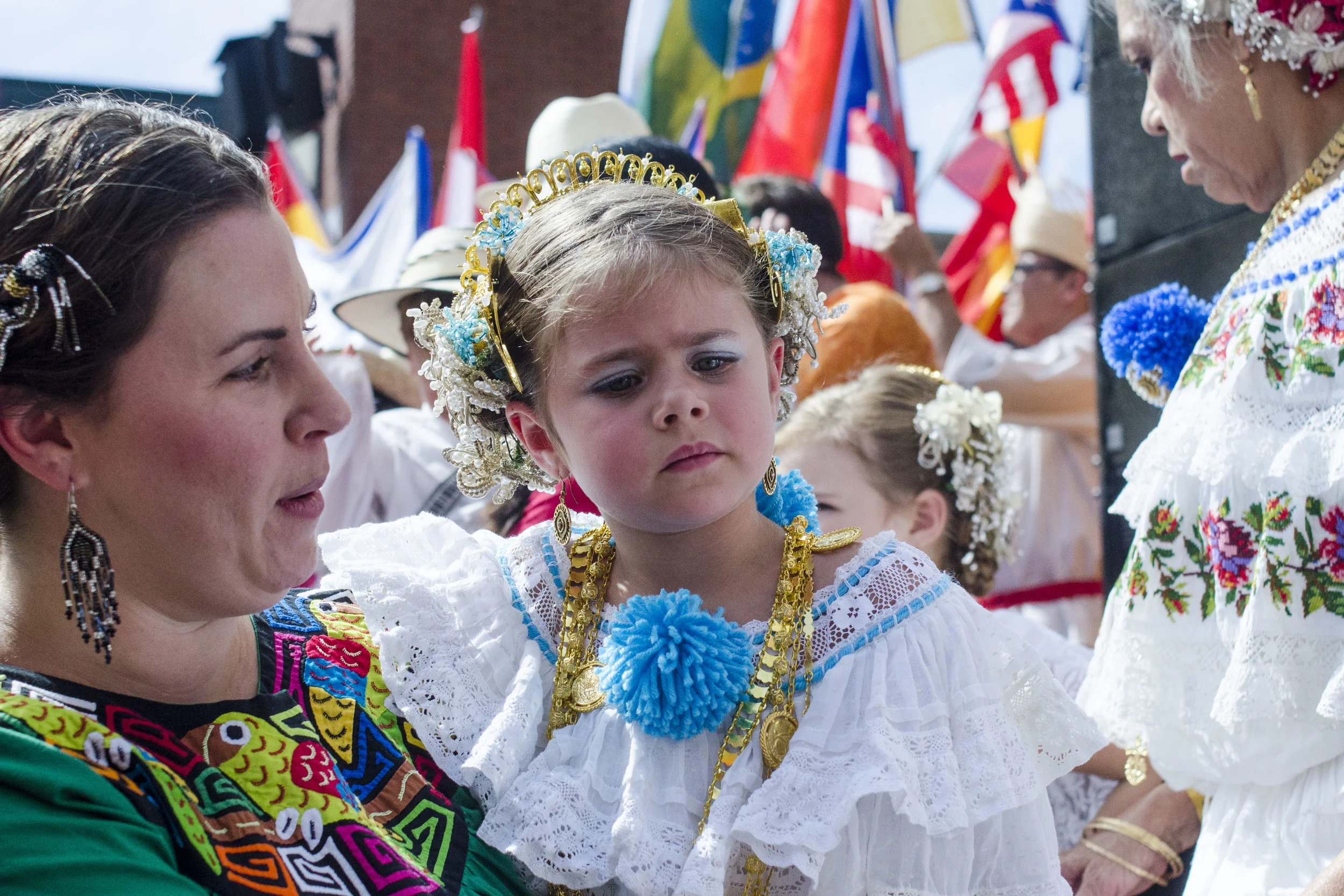 Katerina Keck, 4, held by her mother, Ana Keck, is dressed in traditional Spanish clothing and accessories after a group photo on the steps of Market Square's amphitheater. 