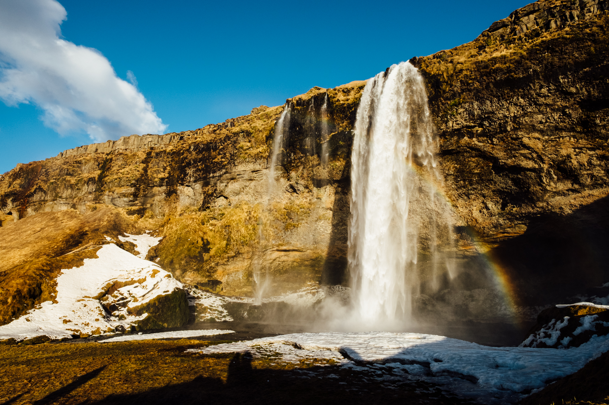  Our first stop was the Seljalandsfoss waterfall. We arrived here right as the sun was setting, so the light couldn’t have been more beautiful - a huge change from the cloudy weather that greeted us when our plane landed just a few hours prior. This 