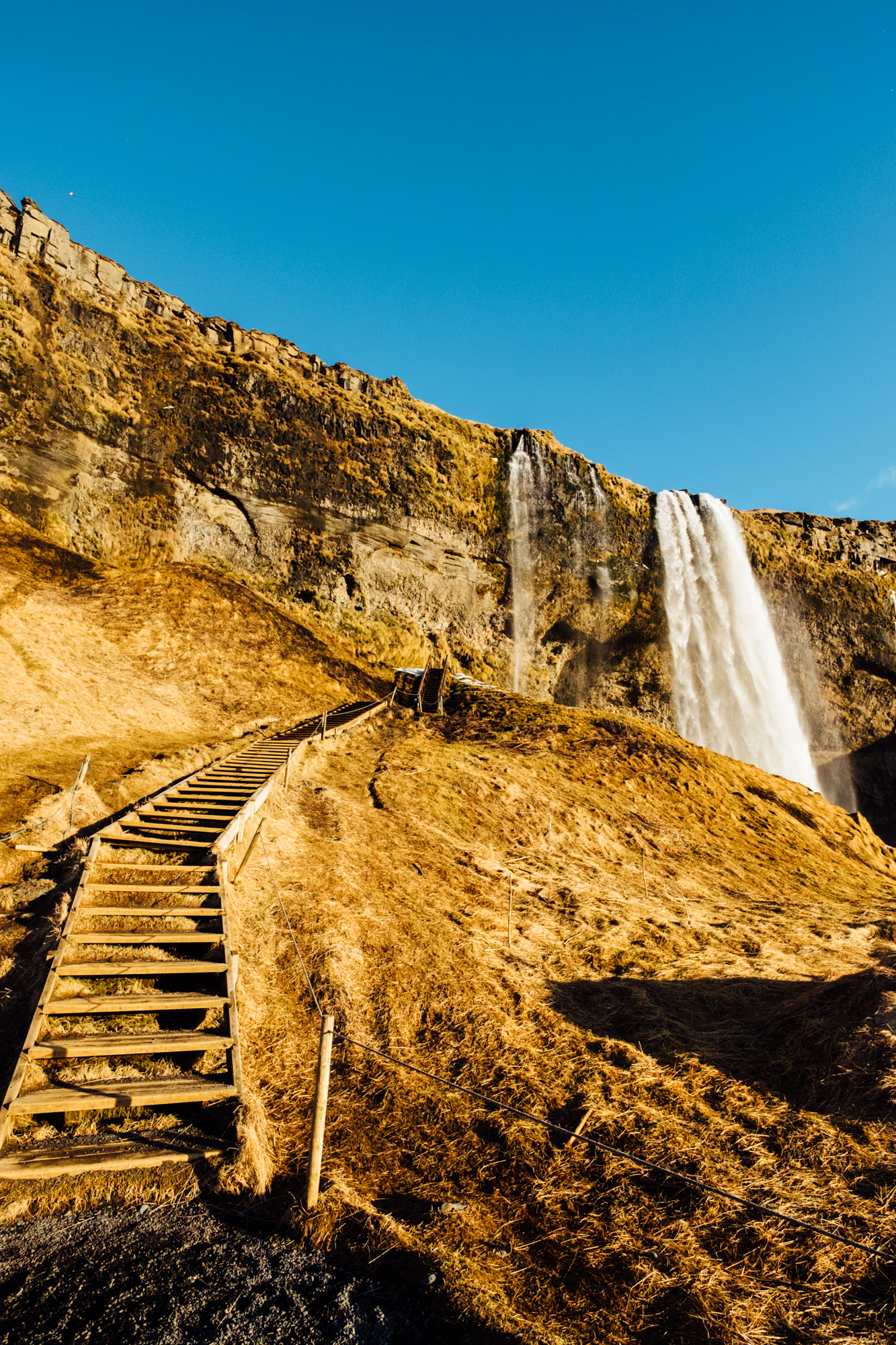  The stairs leading up to the waterfall. We were so lucky to experience some sunshine on our first day in Iceland. It’s pretty rare all year round, but especially in winter. 