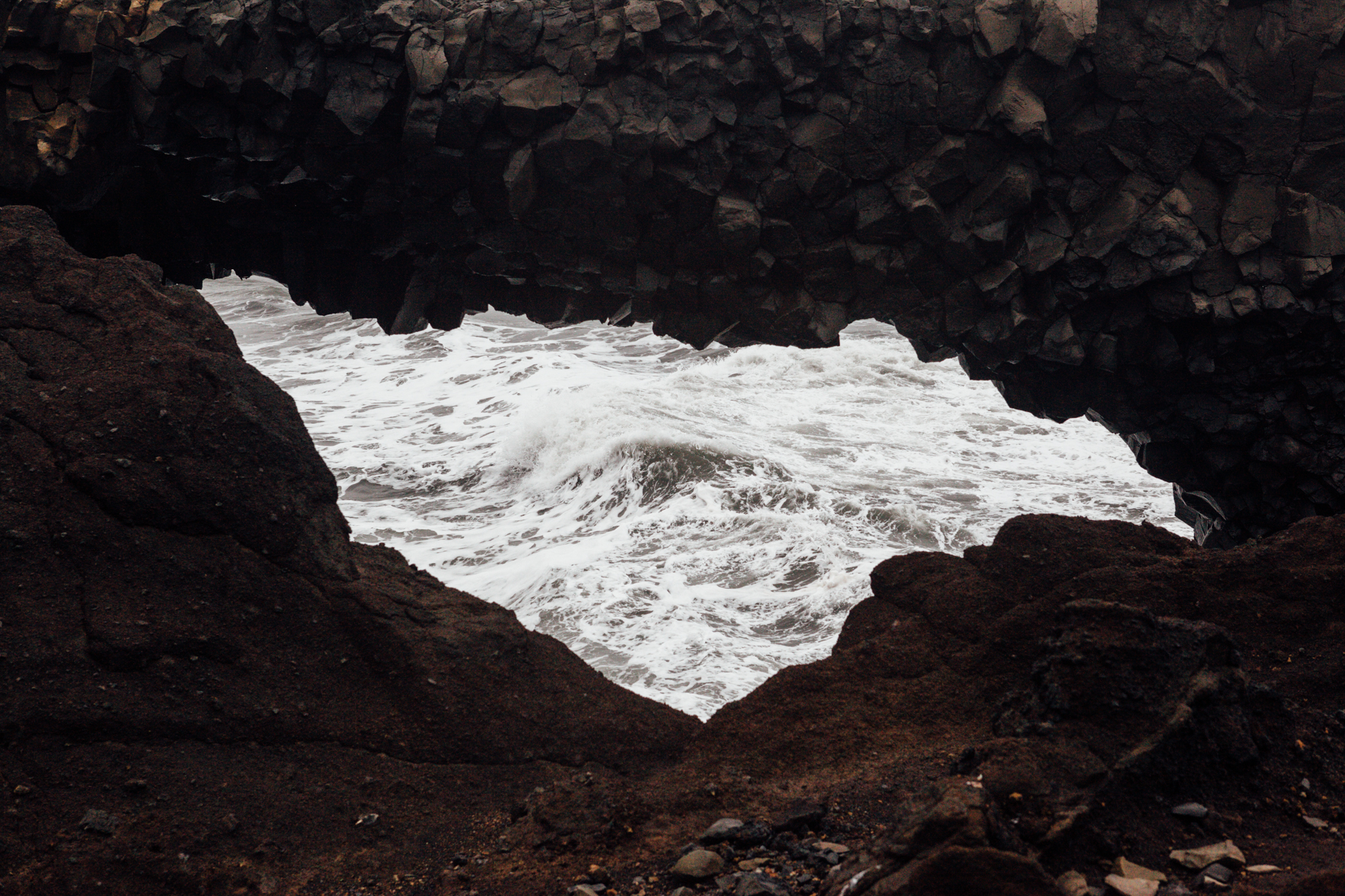Looking through the Dyrhólaey arch at the waves.