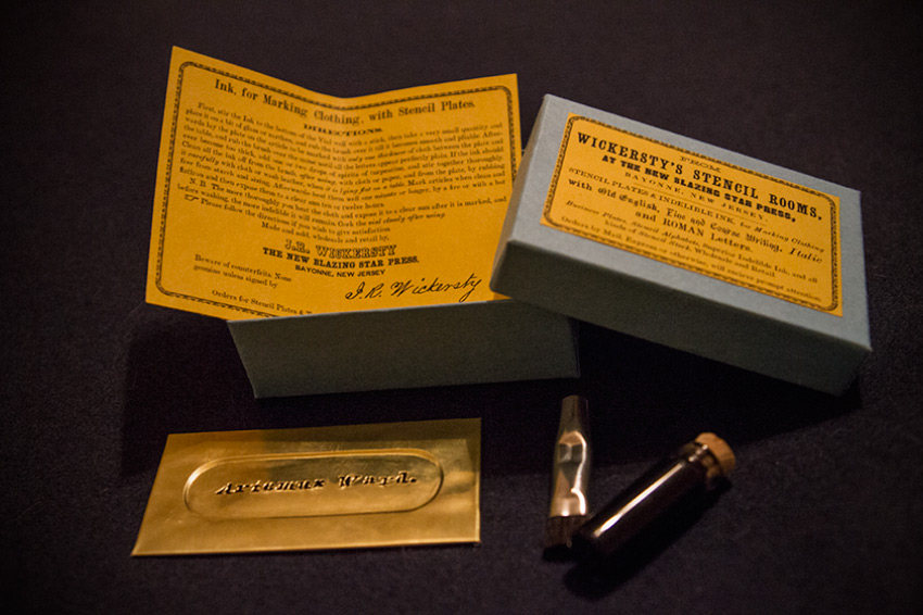 The complete reproduction stencil package, including brass stencil plate, 1/2 dram of black ink, brush, instruction sheet, and a handsome sky-blue box.