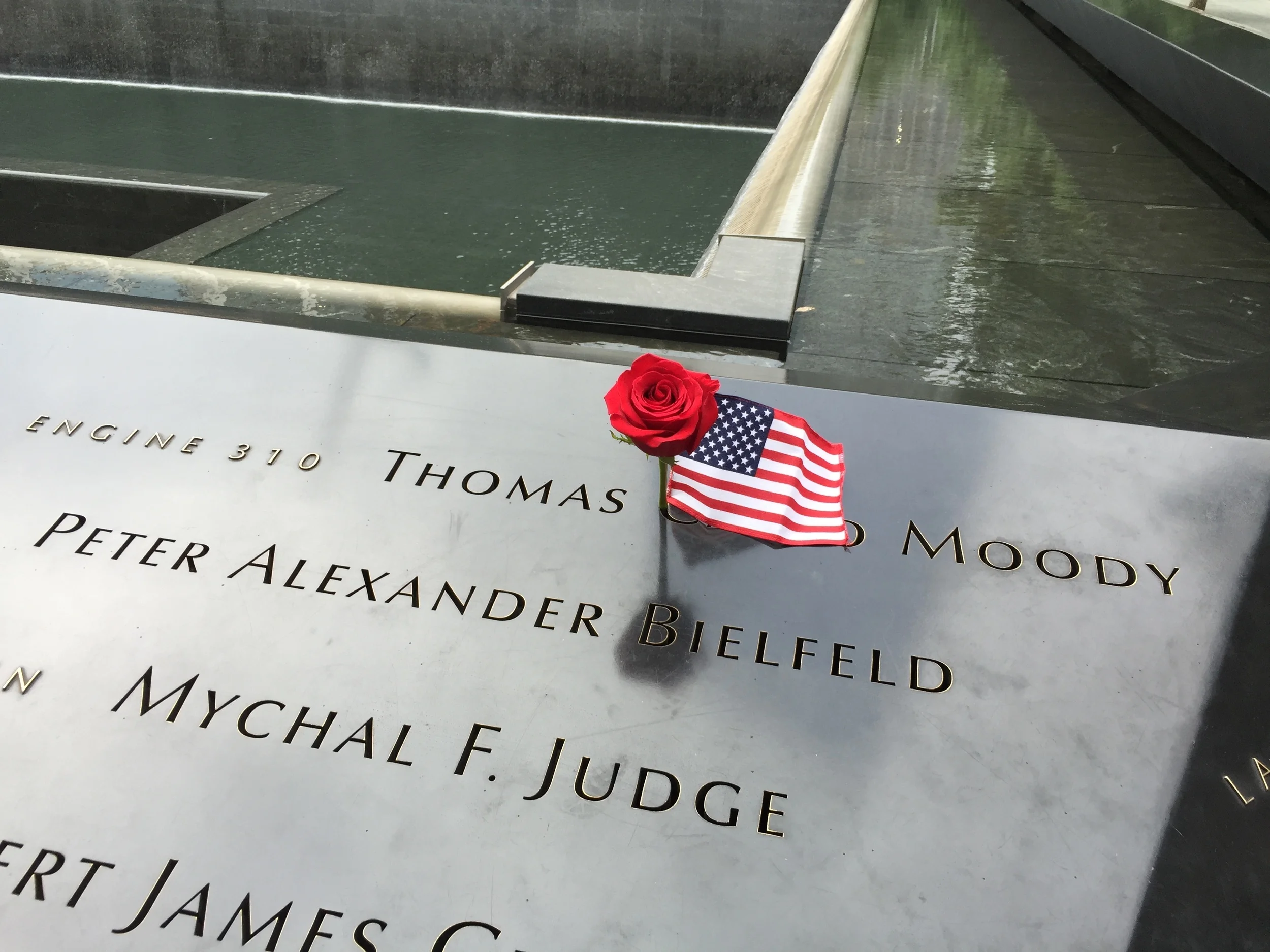 American flag and flower placed on the name of a victim from the New York Fire Department (click to enlarge)