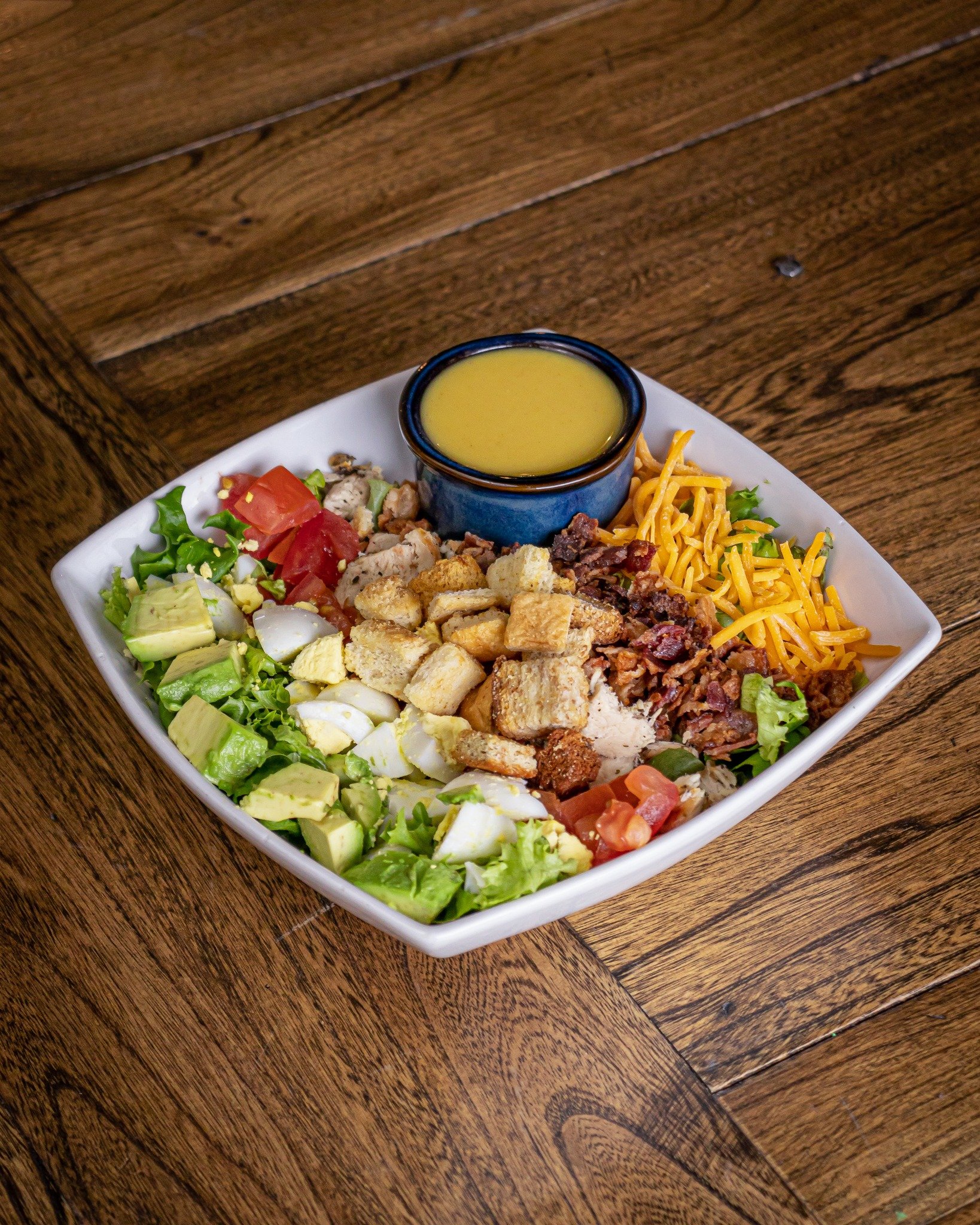 A classic Cobb Salad - what could be better? 🥗

While our featured menu is always evolving with new and delicious options, we have multiple items that stick around; one of them being our Cobb Salad. Made up of mixed greens, chicken, bacon, cheddar, 