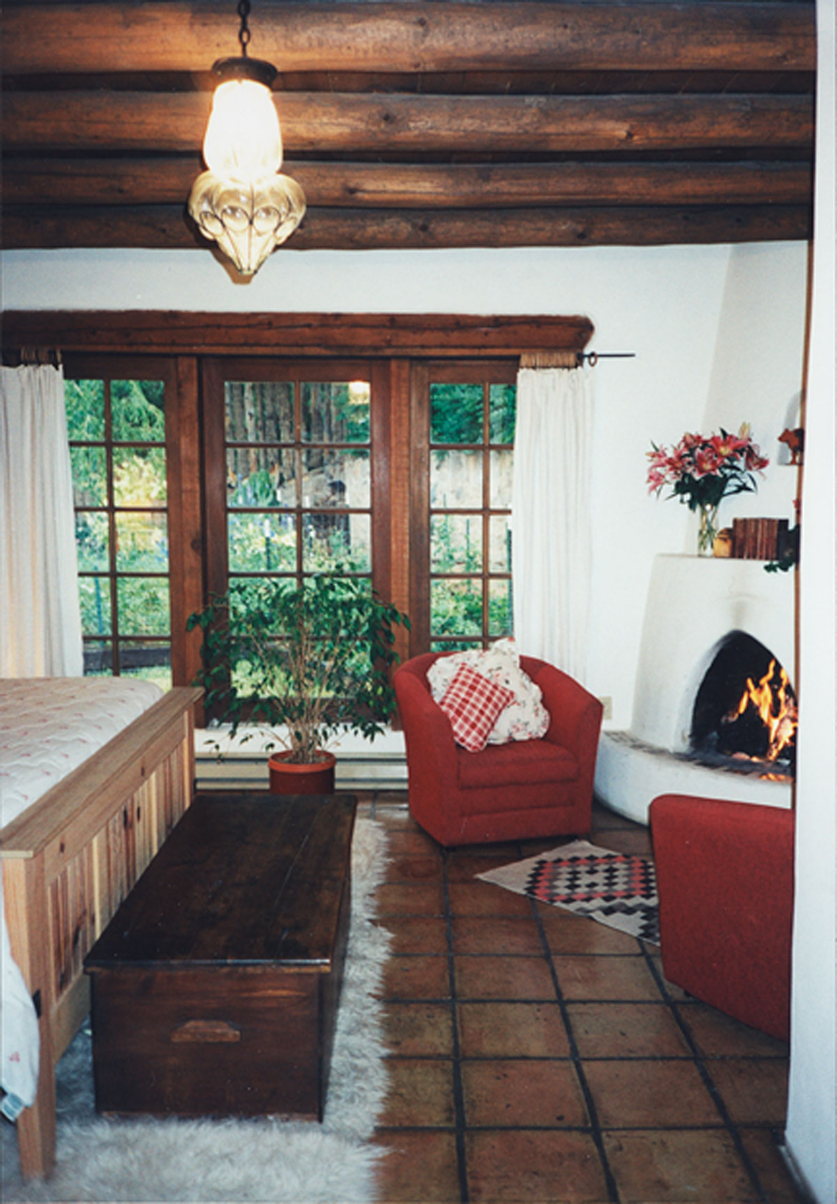B&B suite bedroom with fireplace and view to garden