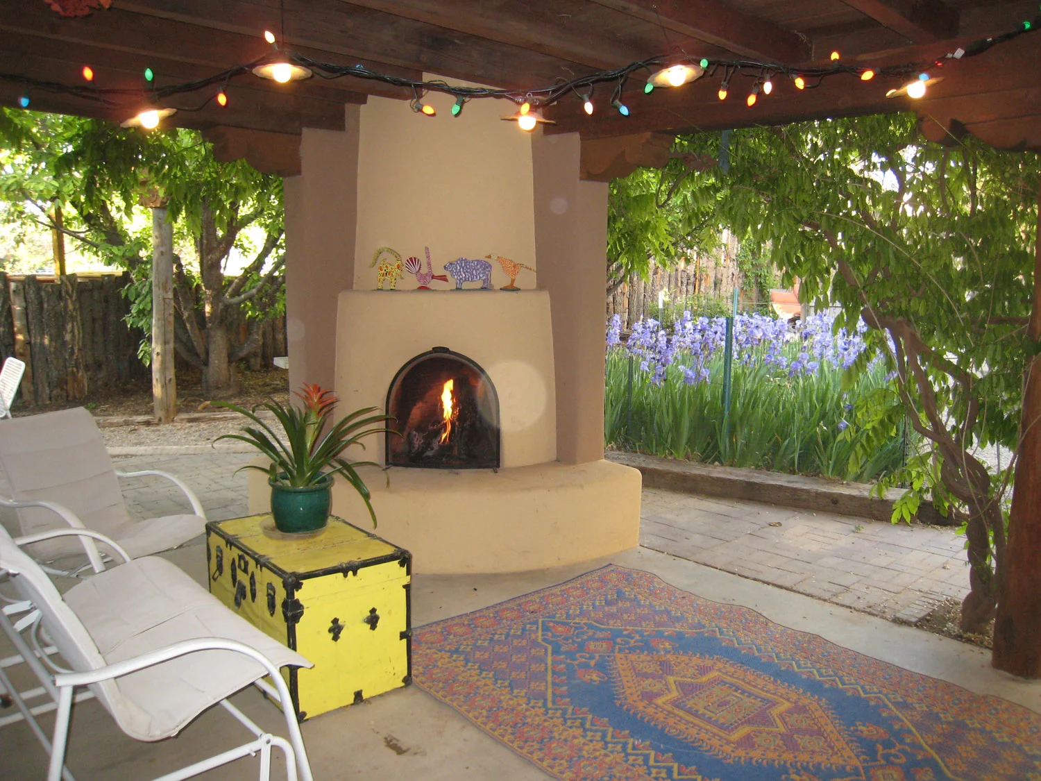 Kiva fireplace on portale overlooking garden