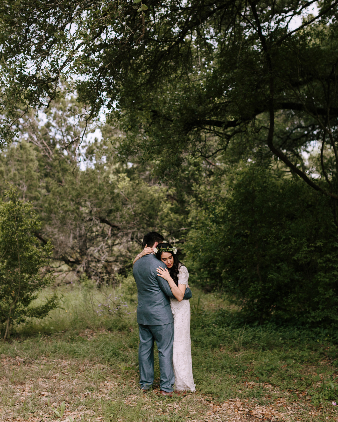 Wimberley Texas Backyard Wedding Bride and Groom Embracing in Forest