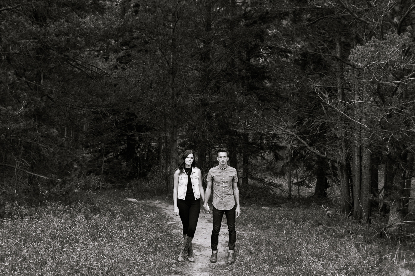 Couple Holding Hands Beside Forest in Black and White