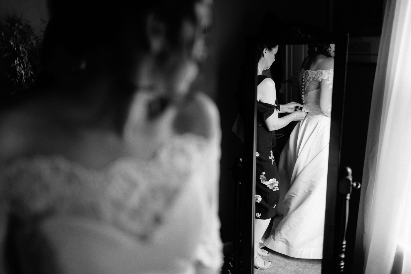 Bride getting ready in front of mirror