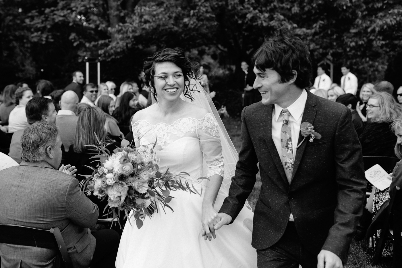 Bride and groom smiling recessional
