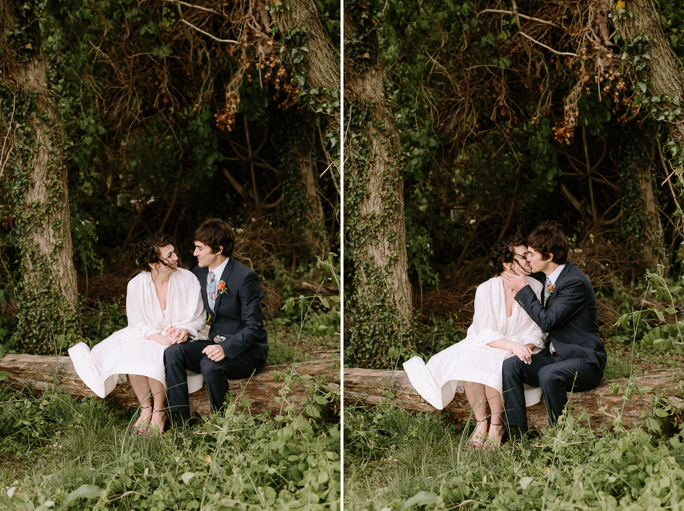 Bride and groom sitting on fallen tree kissing