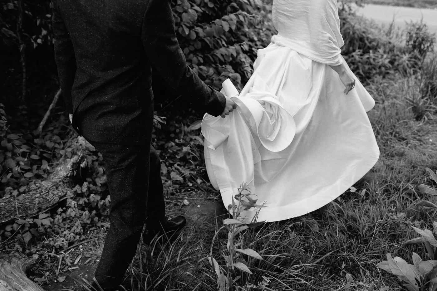 Bride and groom walking with dress black and white
