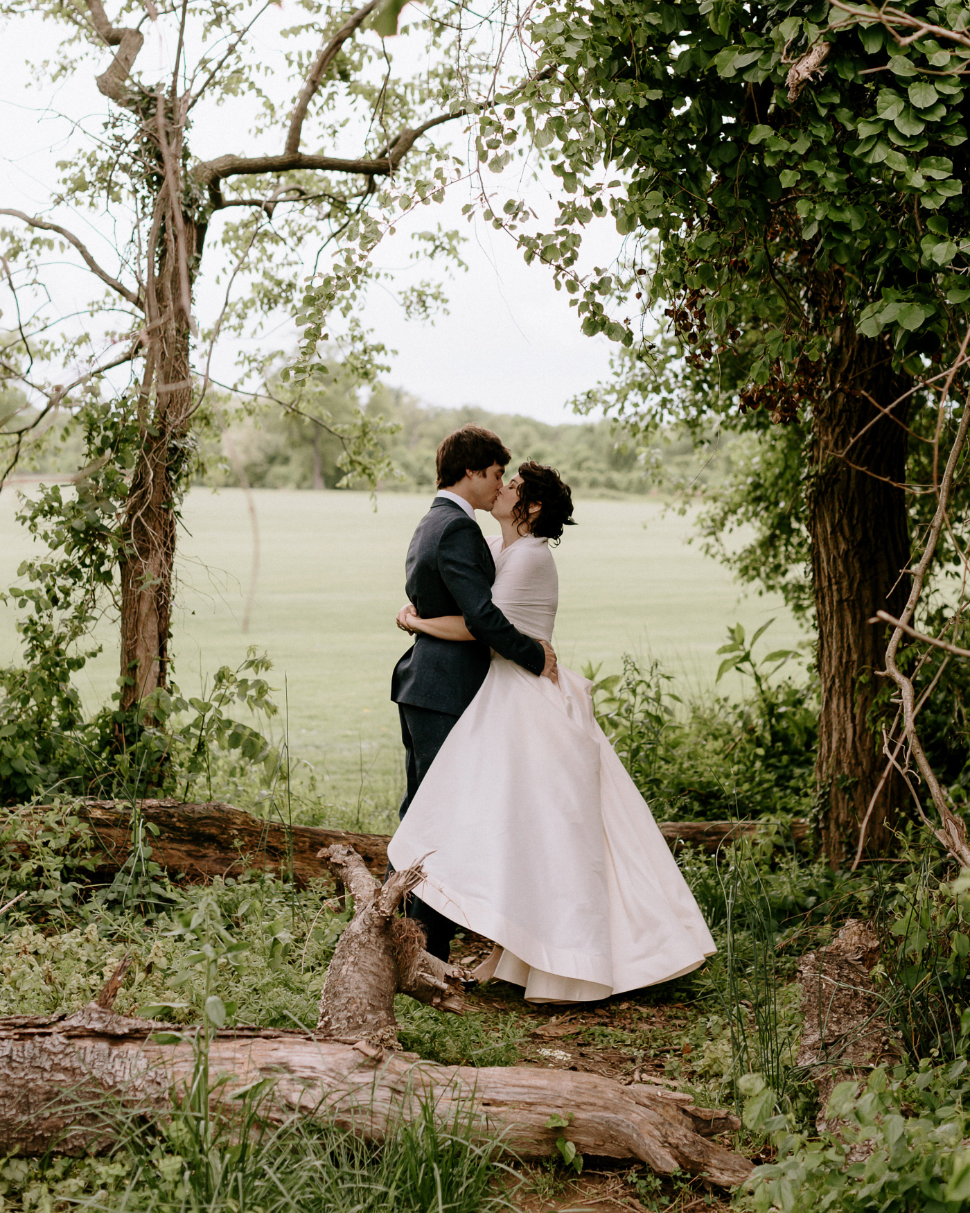 Bride and groom in forest kissing