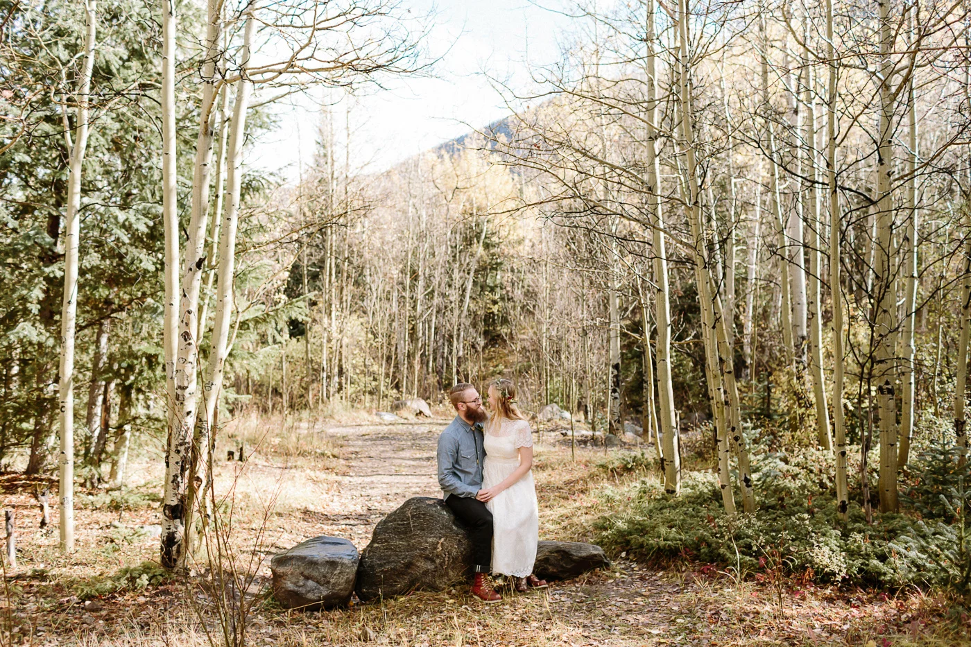 Guanella Pass bride and groom sitting on a rock