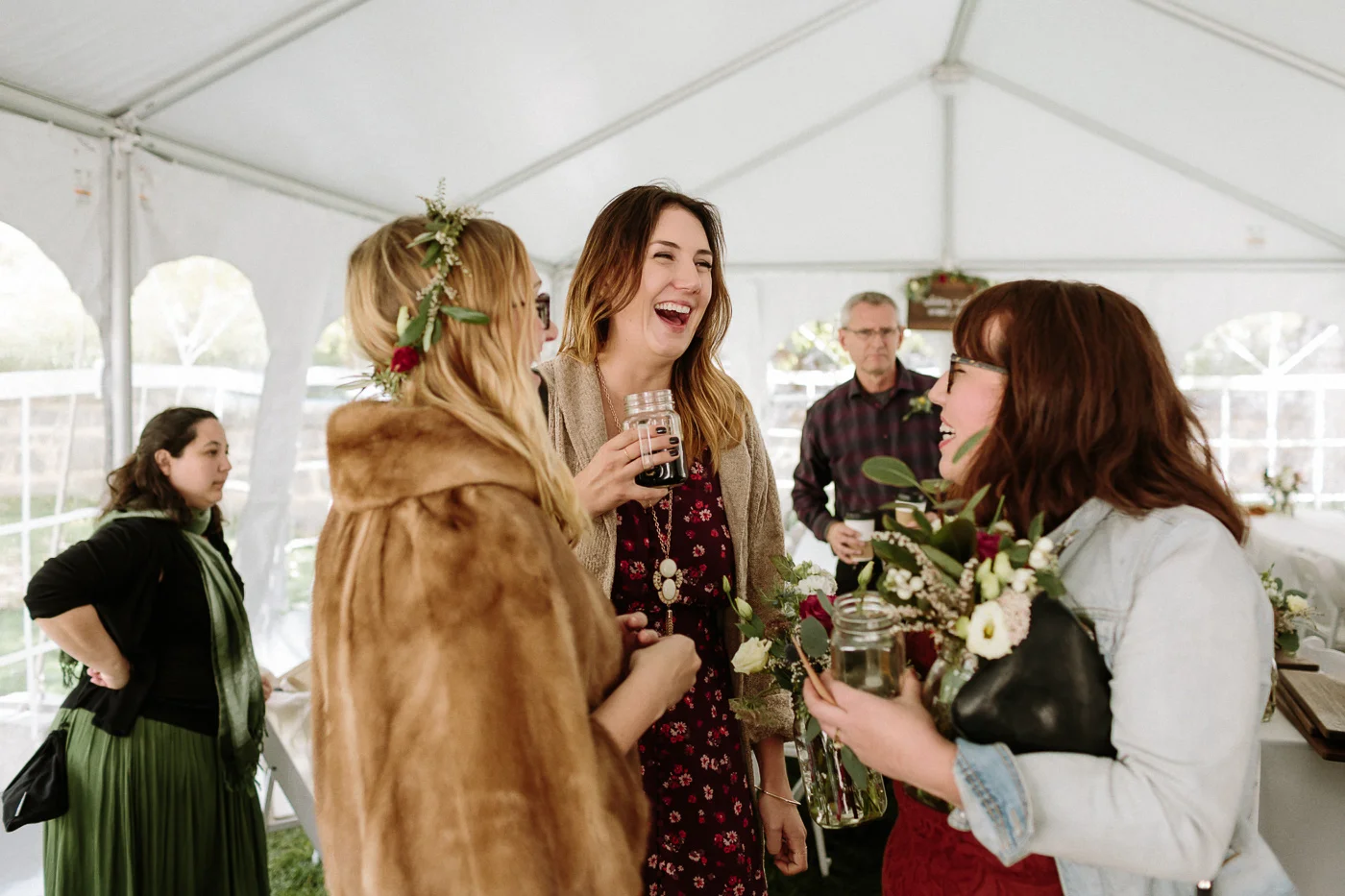 Reception guests laughing with bride