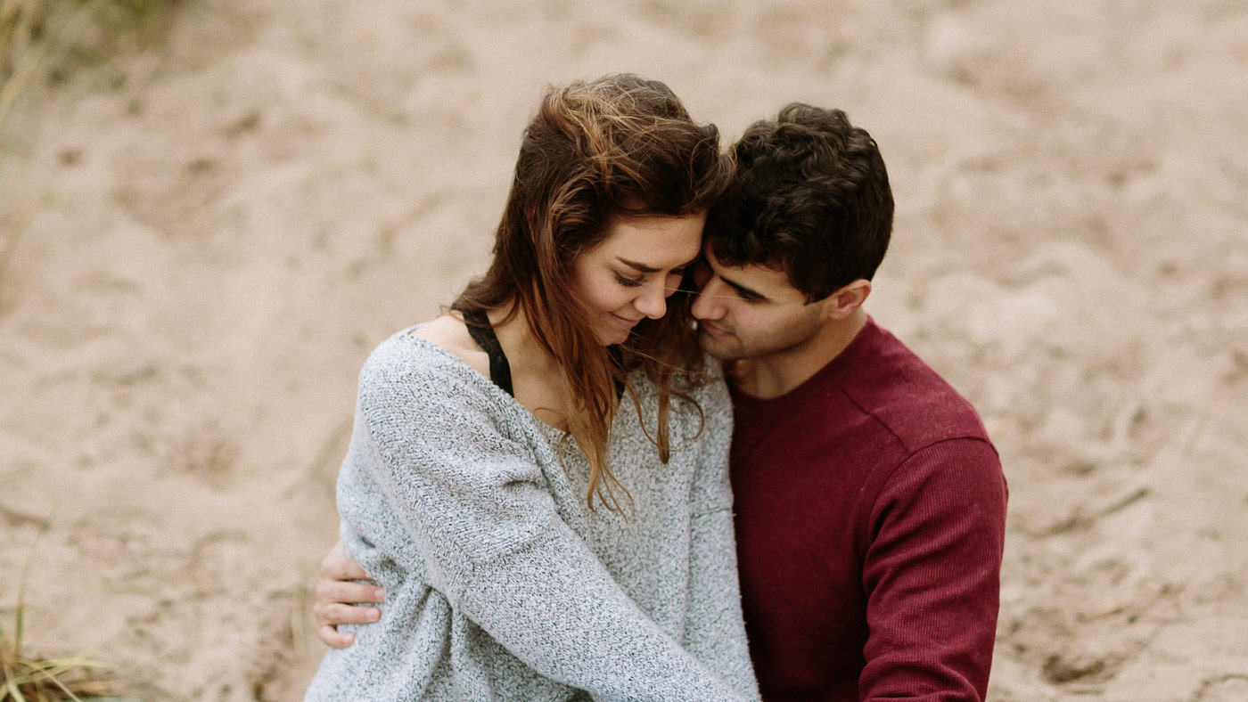 Close up of couple snuggling at the beach