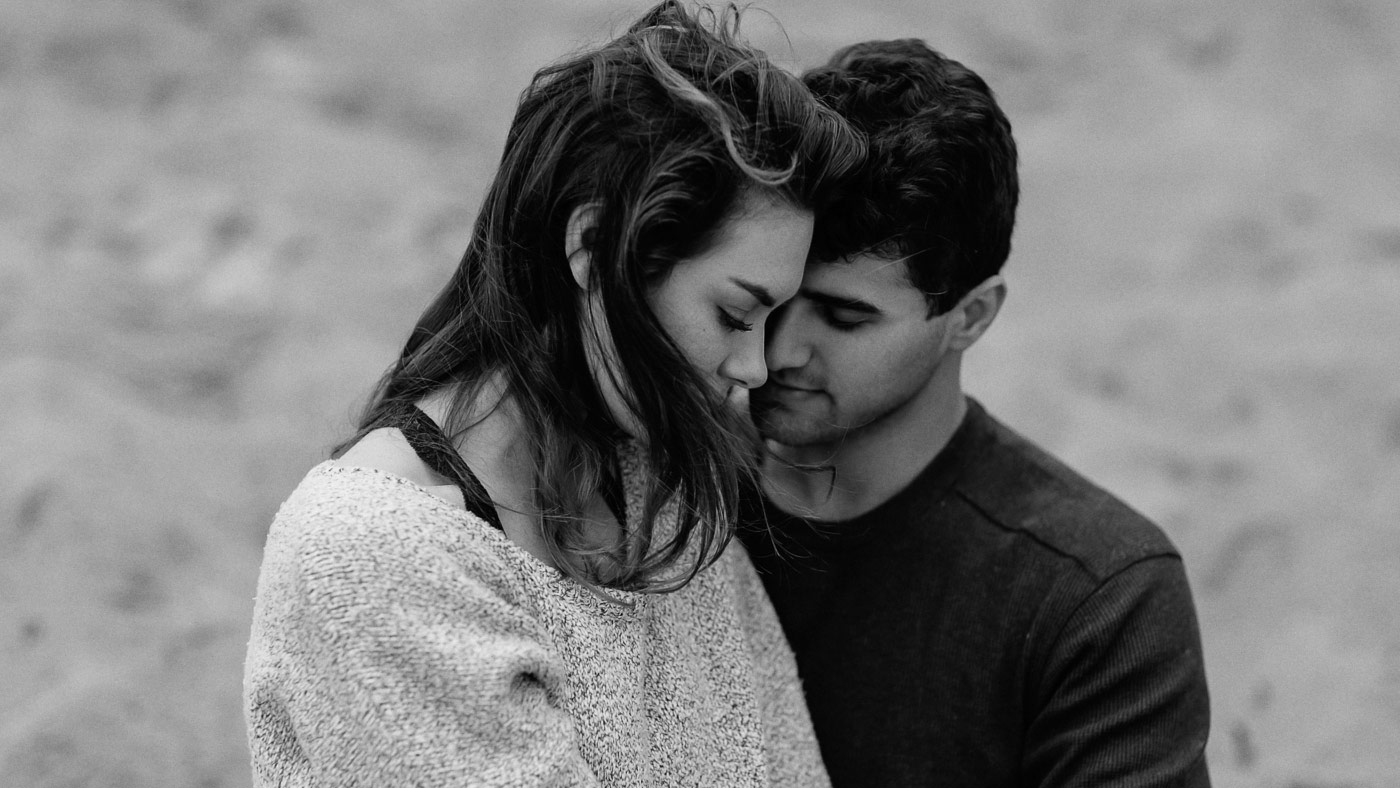 Close up of guy and girl cuddling at the beach