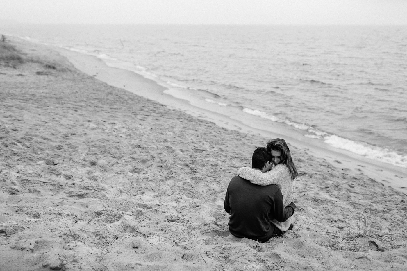 Couple hugging in the sand at Saugatuck Dunes State Park