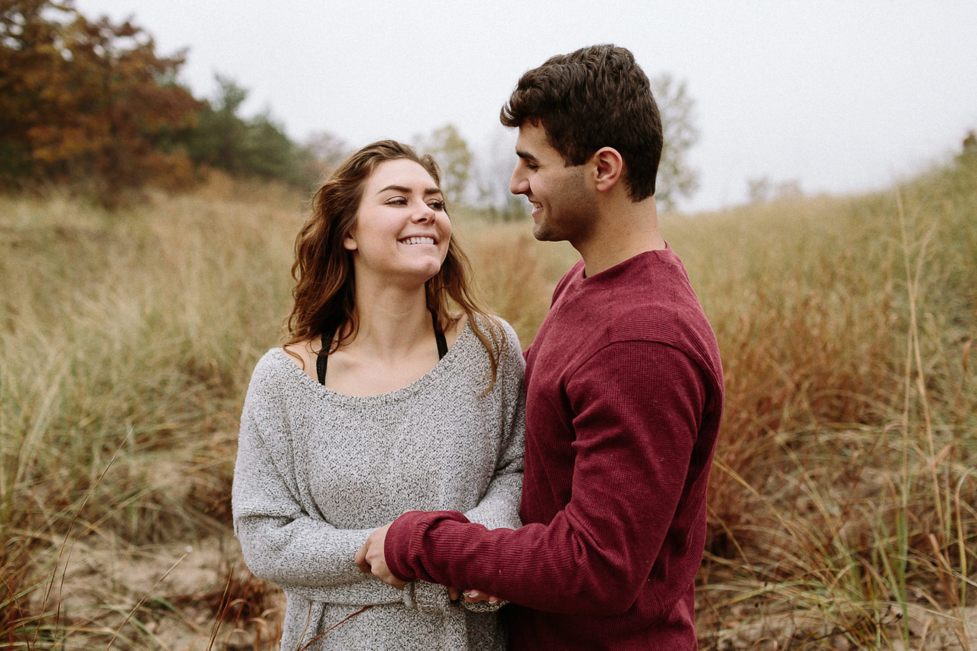 Couple smiling and laughing in the beach grass