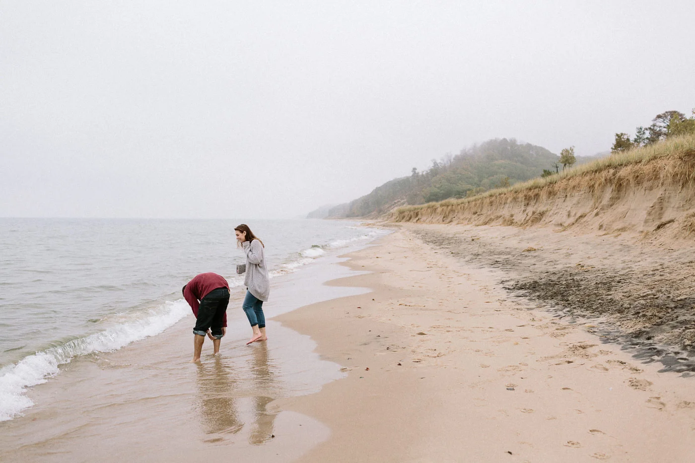 Couple stepping into Lake Michigan