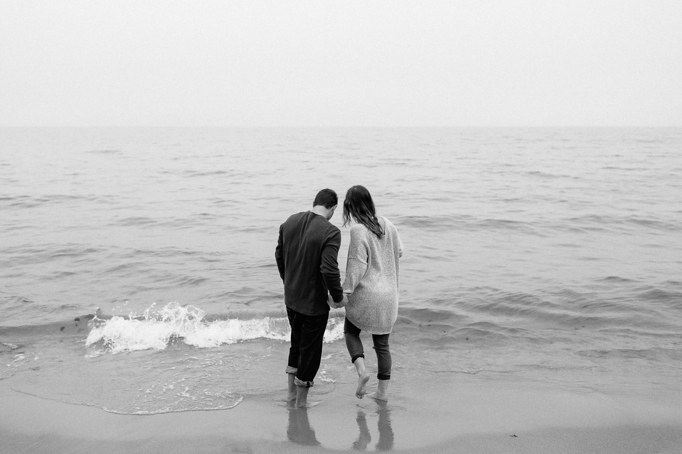 Couple walking into the waves