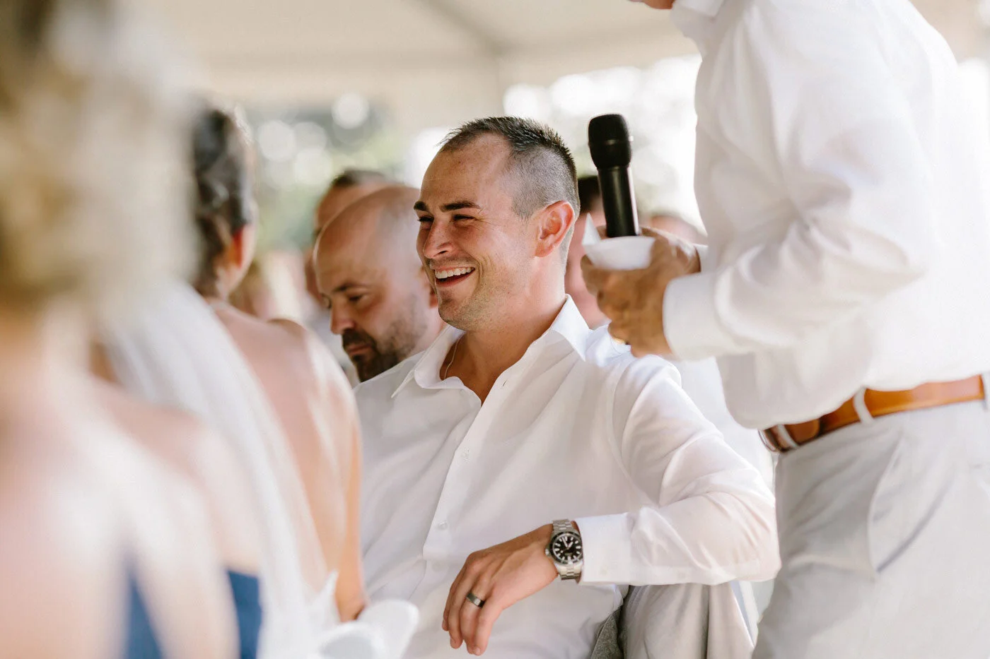 Groom laugh during his father's toast