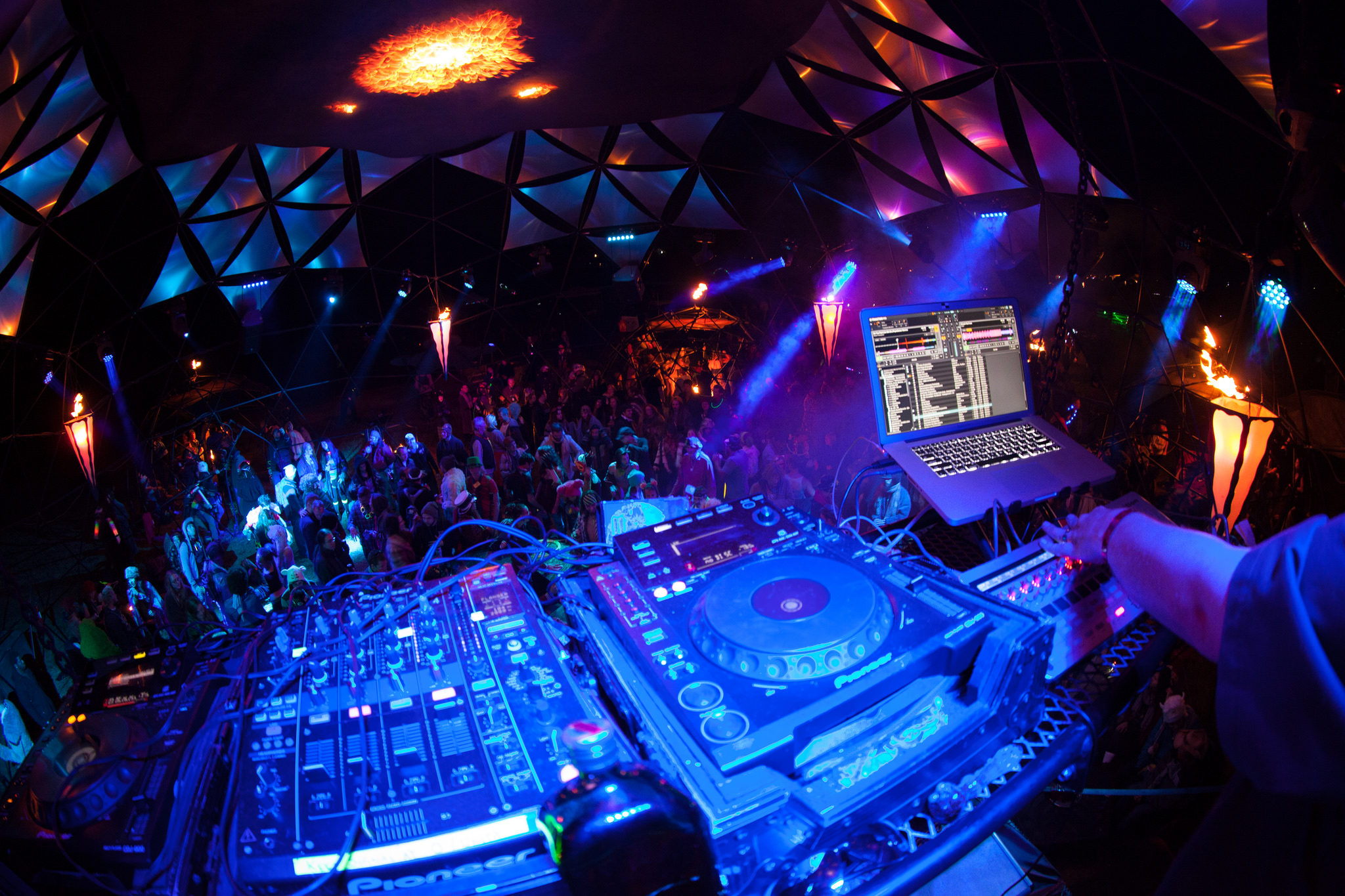 A DJ keeps the crowd moving from above
