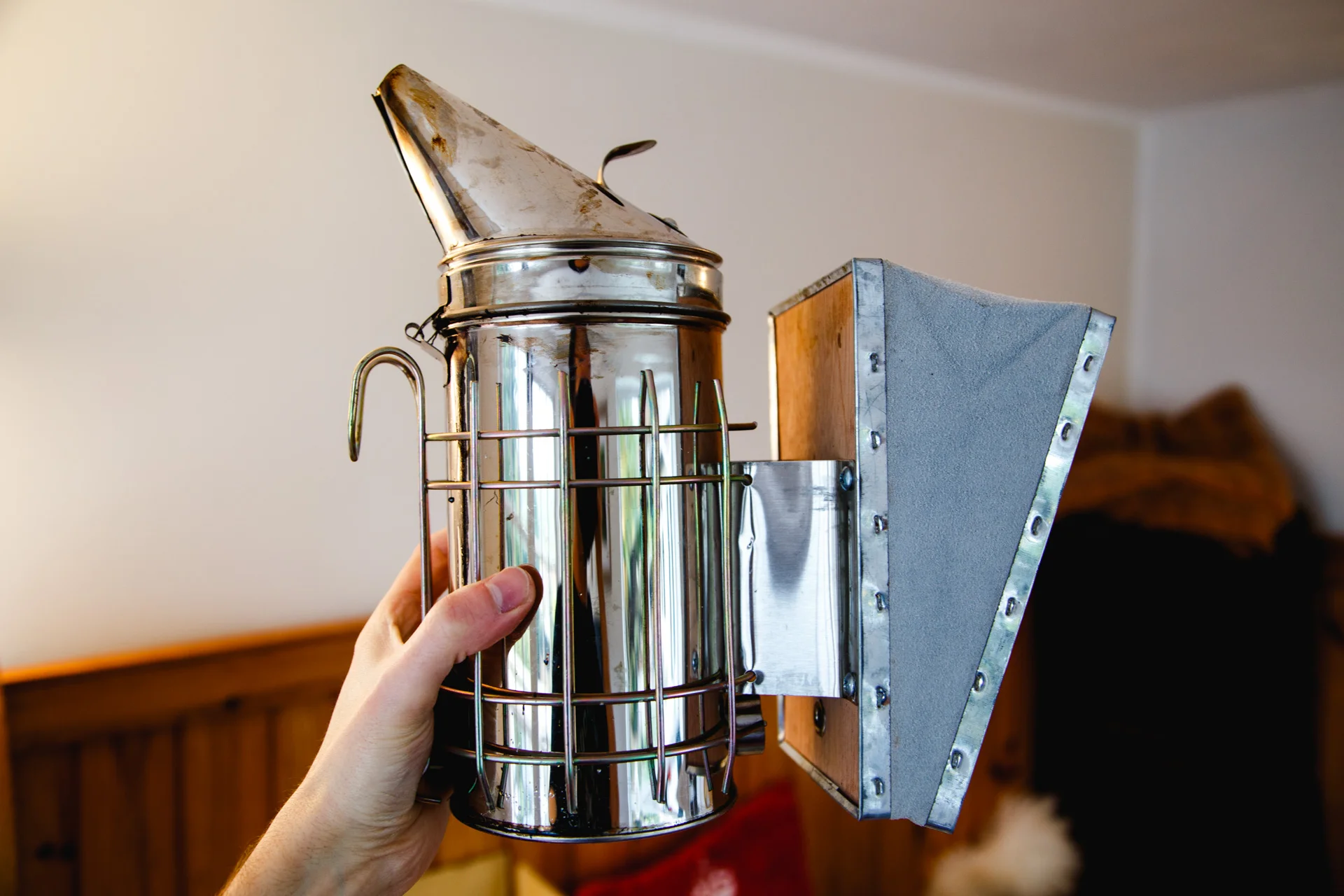 One of the tools for bee keeping - a smoker. Smoke will be directed towards the area that wants to be cleared for working. One theory is that it replicates a possible forest fire and that the bees will move to other areas of the hive and gather food and nectar. This can make them less aggressive too.