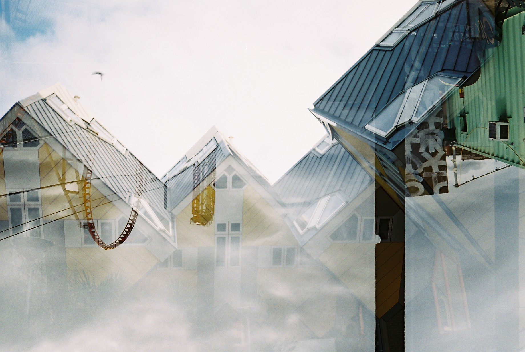 This photo was taken in Rotterdam, the Netherlands, and New York with @joyce_division . She borrowed a friend's camera and it loaded film in the opposite direction. This lead to the cool image of an upside down roller coaster from Coney Island over her image. 