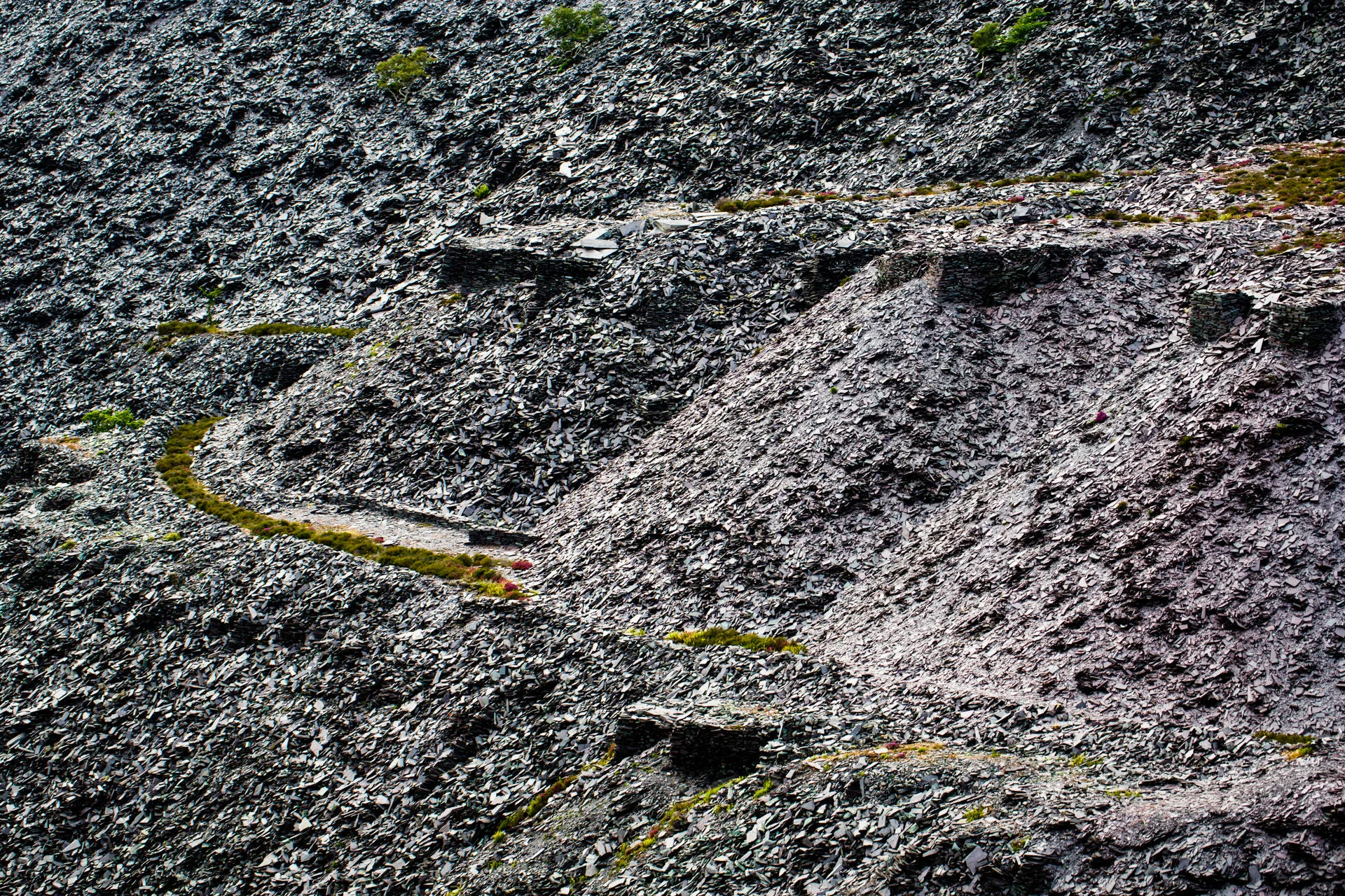 Pathway weaves around the mounds of slate.