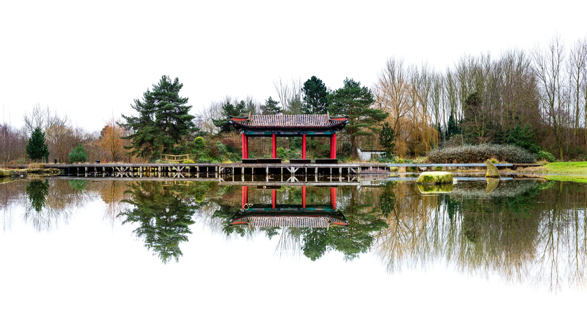 The way the frozen surface of the lake was allowed me to get a very still reflection. As there were no clouds or blue sky I decided to blow it out and go for a white background to allow the pagoda and trees to stand out.