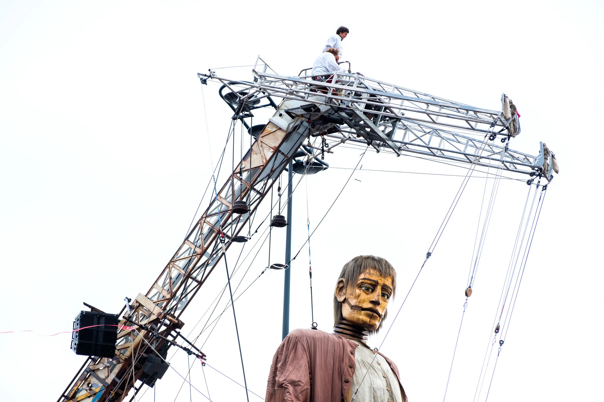 Lilliputians riding on top of the Giant’s crane.