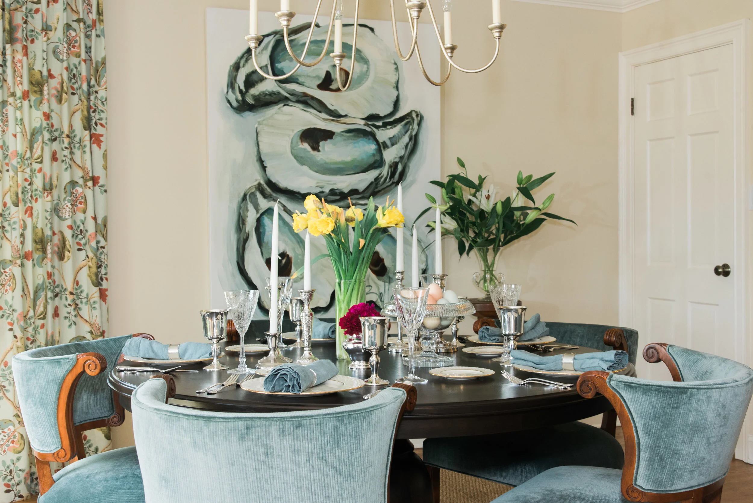 Like the house, this table is luxurious without being overdressed. Artwork: Bellamy | Chairs: H ickory Chair | Chair Fabric: Pollack | Table: Custom design by Calvert Dean Design| Chandelier: Currey & Company